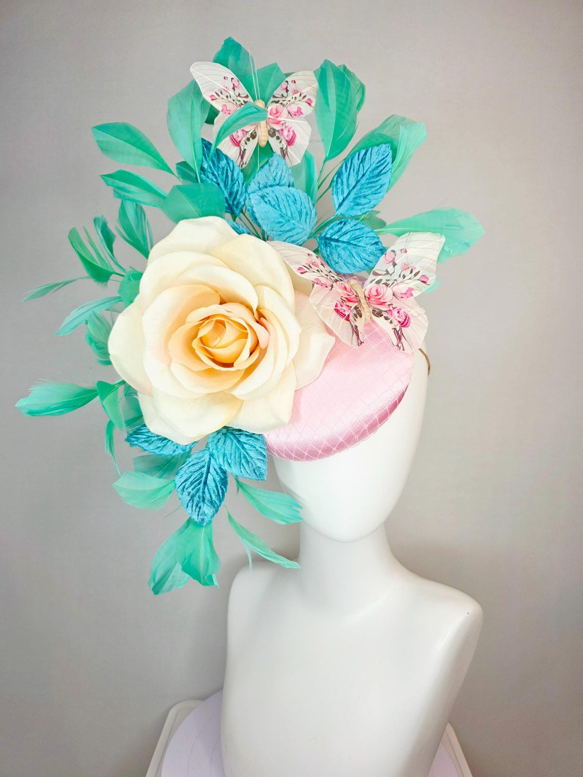kentucky derby hat fascinator light pink satin with netting ivory cream satin rose turquoise blue leaves mint green feathers and butterflies