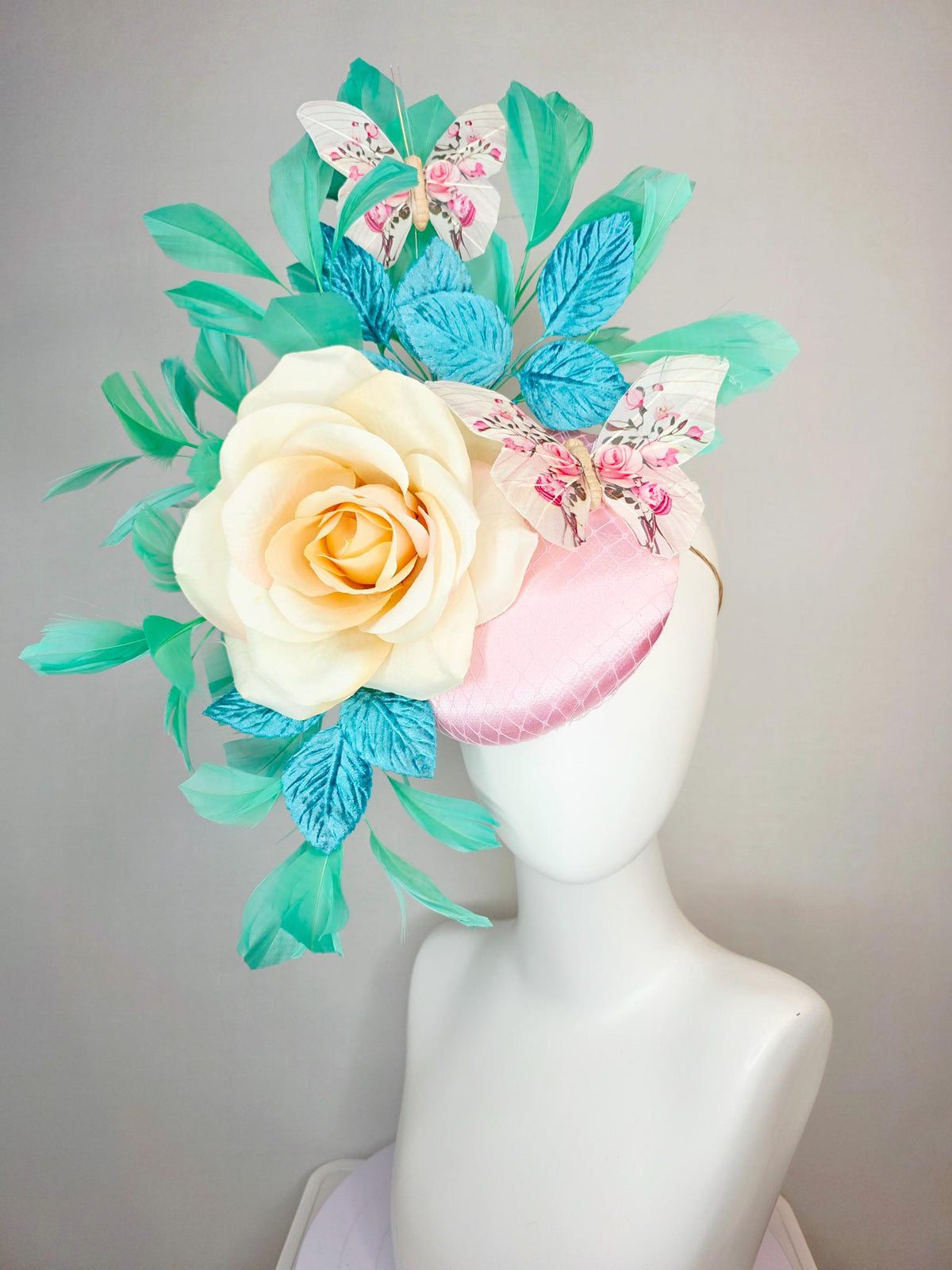 kentucky derby hat fascinator light pink satin with netting ivory cream satin rose turquoise blue leaves mint green feathers and butterflies