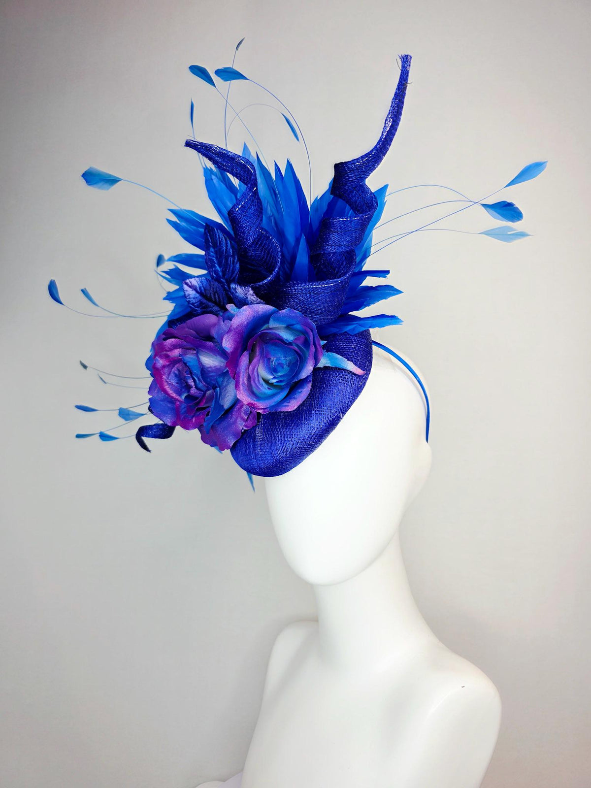 kentucky derby hat fascinator cobalt blue sinamay with curls ombre pink purple blue satin roses blue leaves royal blue branching feathers