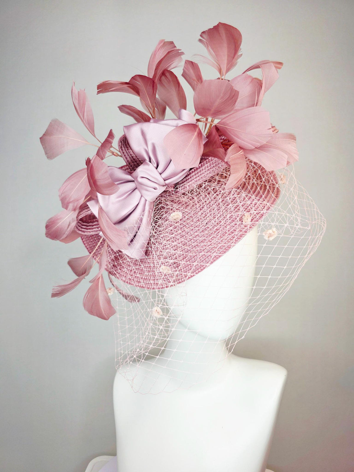 kentucky derby hat fascinator dusty mauve pink straw saucer with lilac pink satin bow dusty pink branching feathers light pink mesh veil