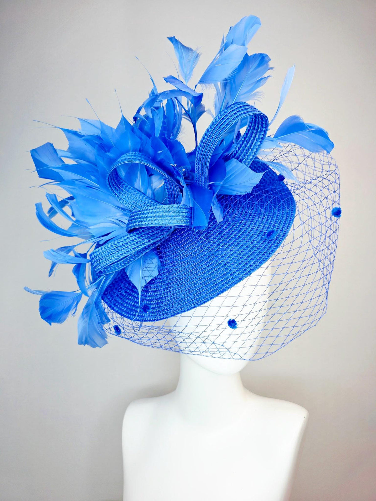 kentucky derby hat fascinator cobalt blue straw saucer with cobalt blue straw bow royal blue feathers and cobalt blue mesh veil