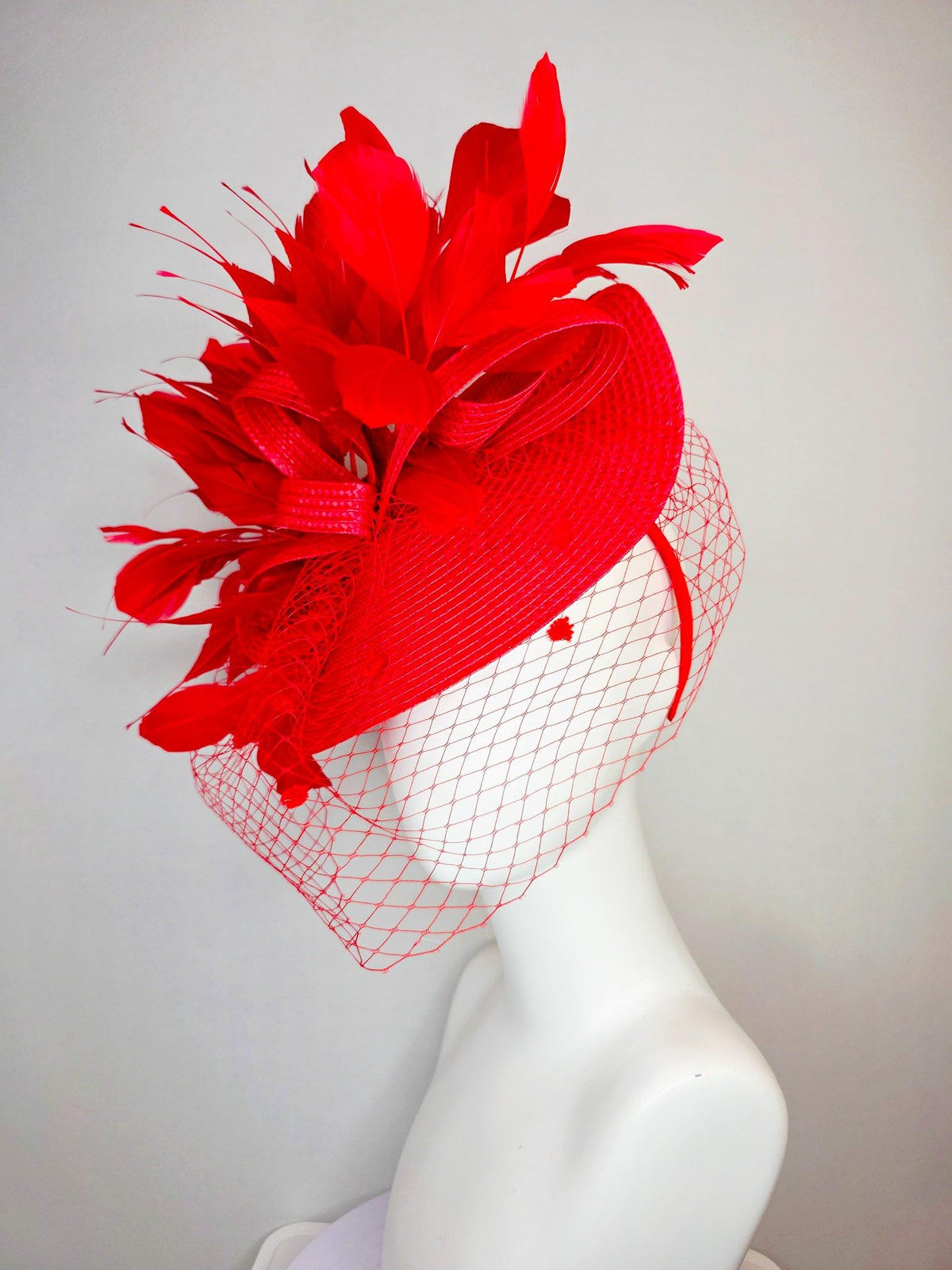 kentucky derby hat fascinator scarlet red straw saucer with red straw bow with bright red branching feathers and red mesh veil