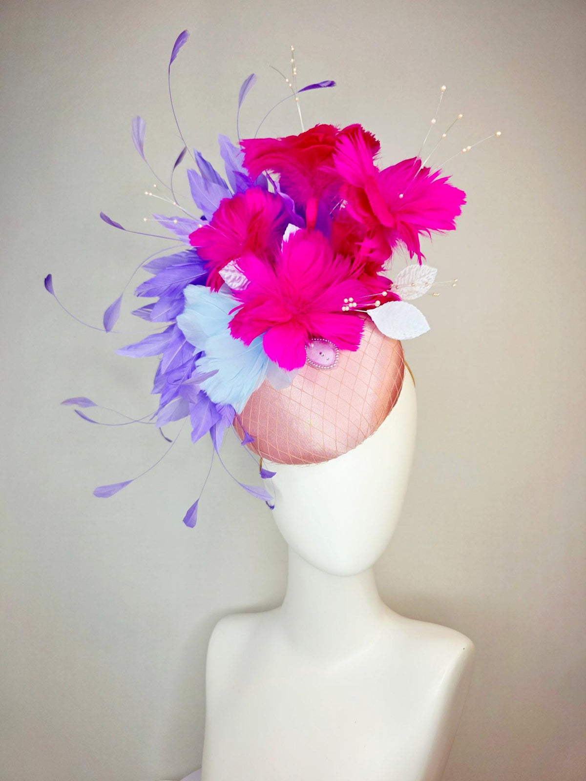 kentucky derby hat fascinator dusty pink satin with netting light blue fuchsia pink feather flowers white leaves lavender purple feathers