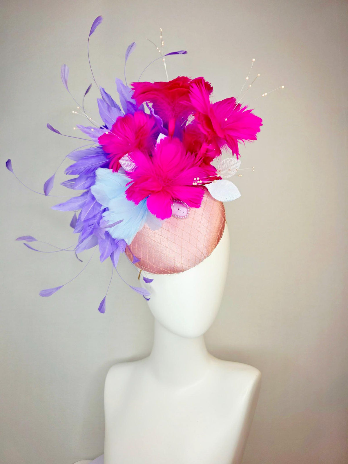 kentucky derby hat fascinator dusty pink satin with netting light blue fuchsia pink feather flowers white leaves lavender purple feathers