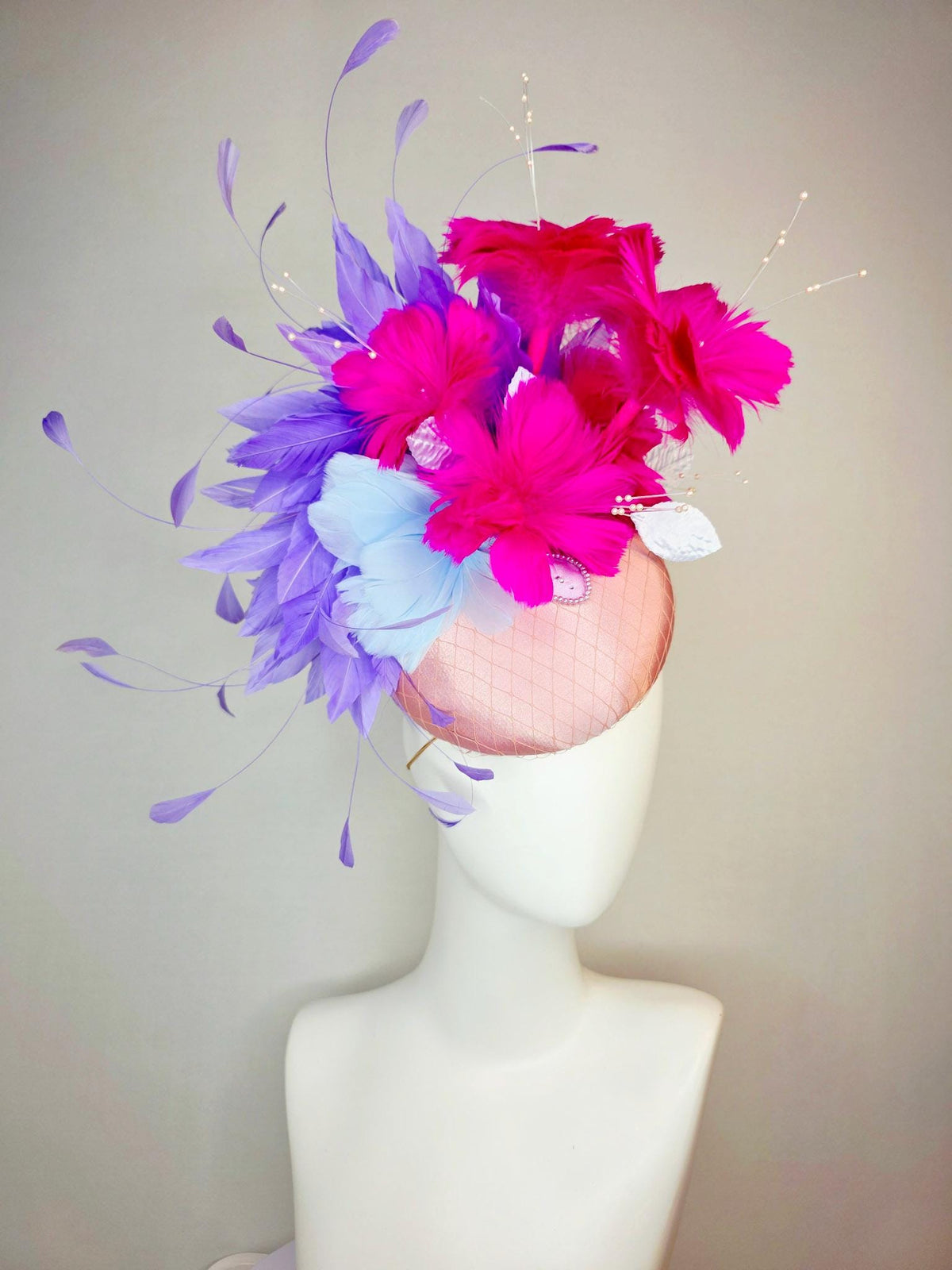 kentucky derby hat fascinator dusty pink satin with netting light blue fuchsia pink feather flowers white leaves lavender purple feathers