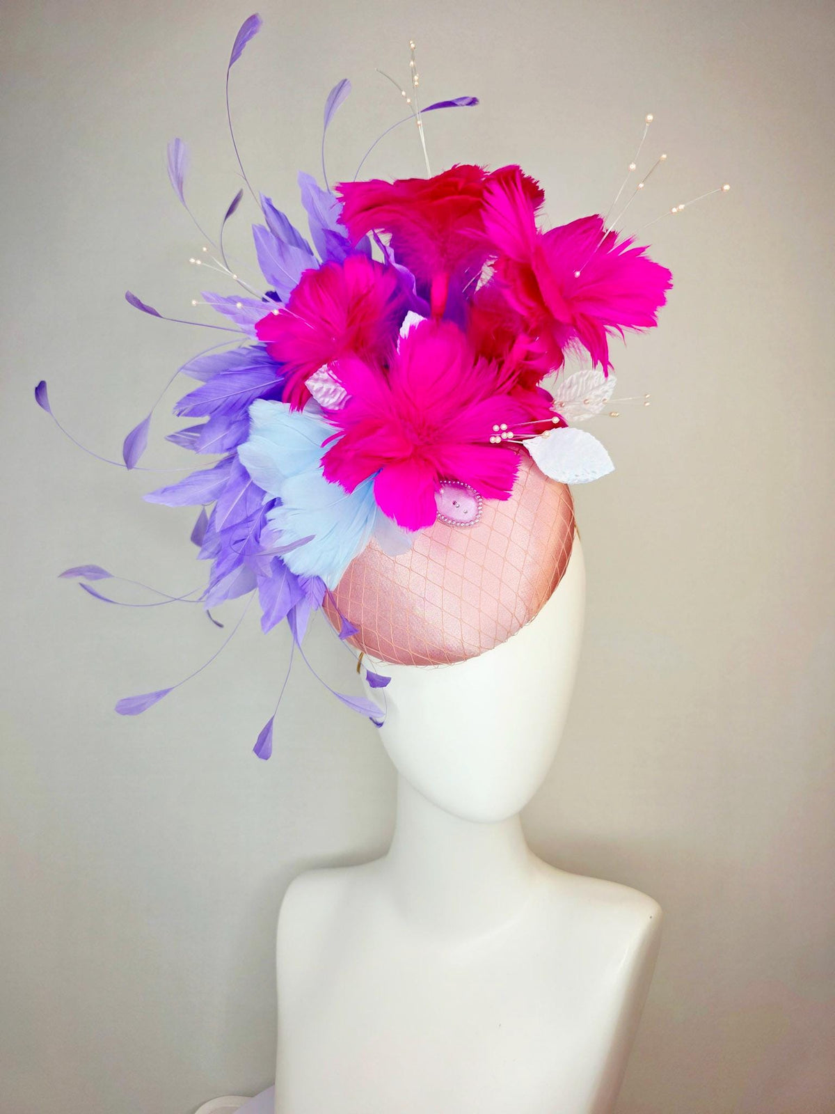 kentucky derby hat fascinator dusty pink satin with netting light blue fuchsia pink feather flowers white leaves lavender purple feathers