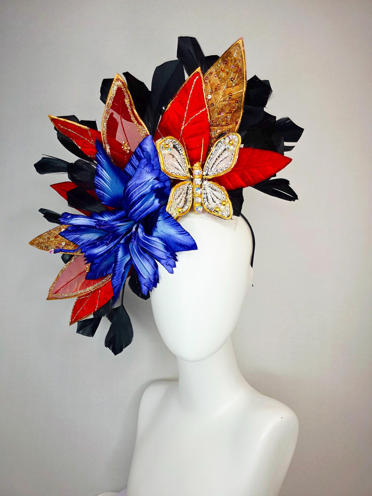 kentucky derby hat fascinator large royal blue satin flower red and gold organza satin leaves black branching feathers gold pearl butterfly