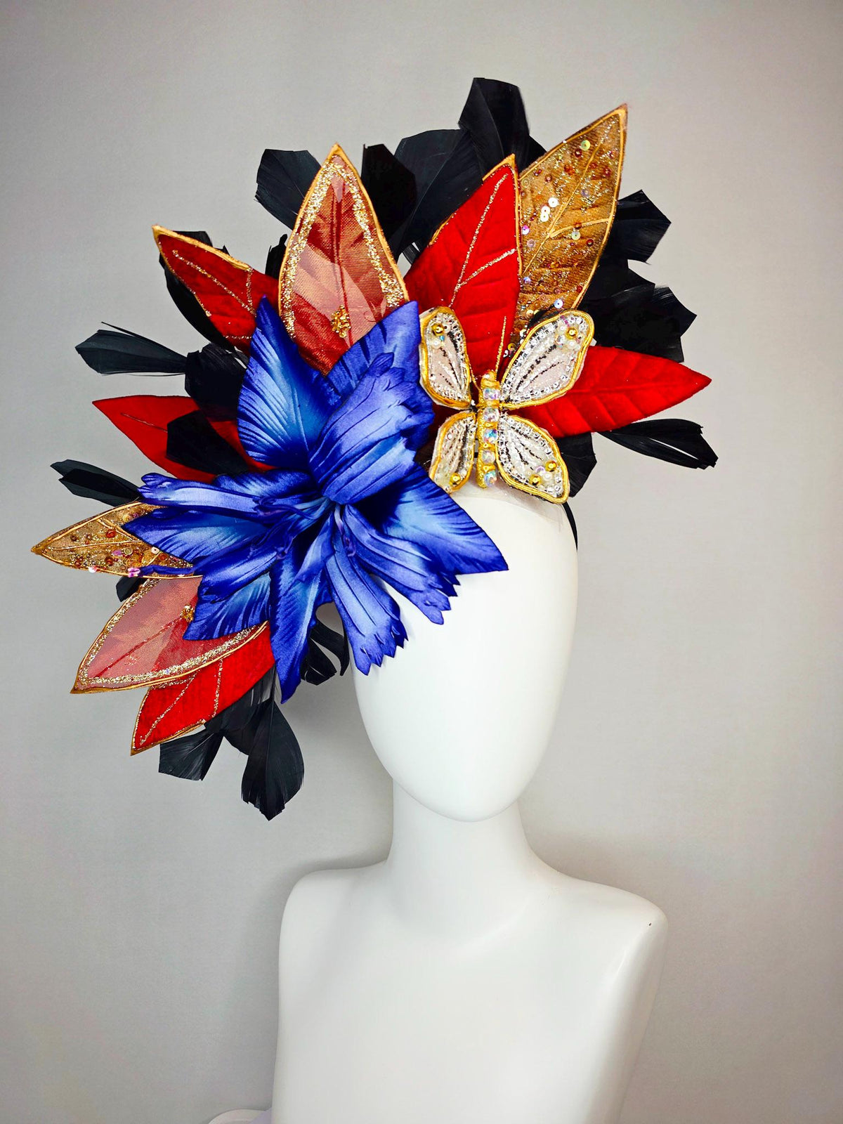 kentucky derby hat fascinator large royal blue satin flower red and gold organza satin leaves black branching feathers gold pearl butterfly