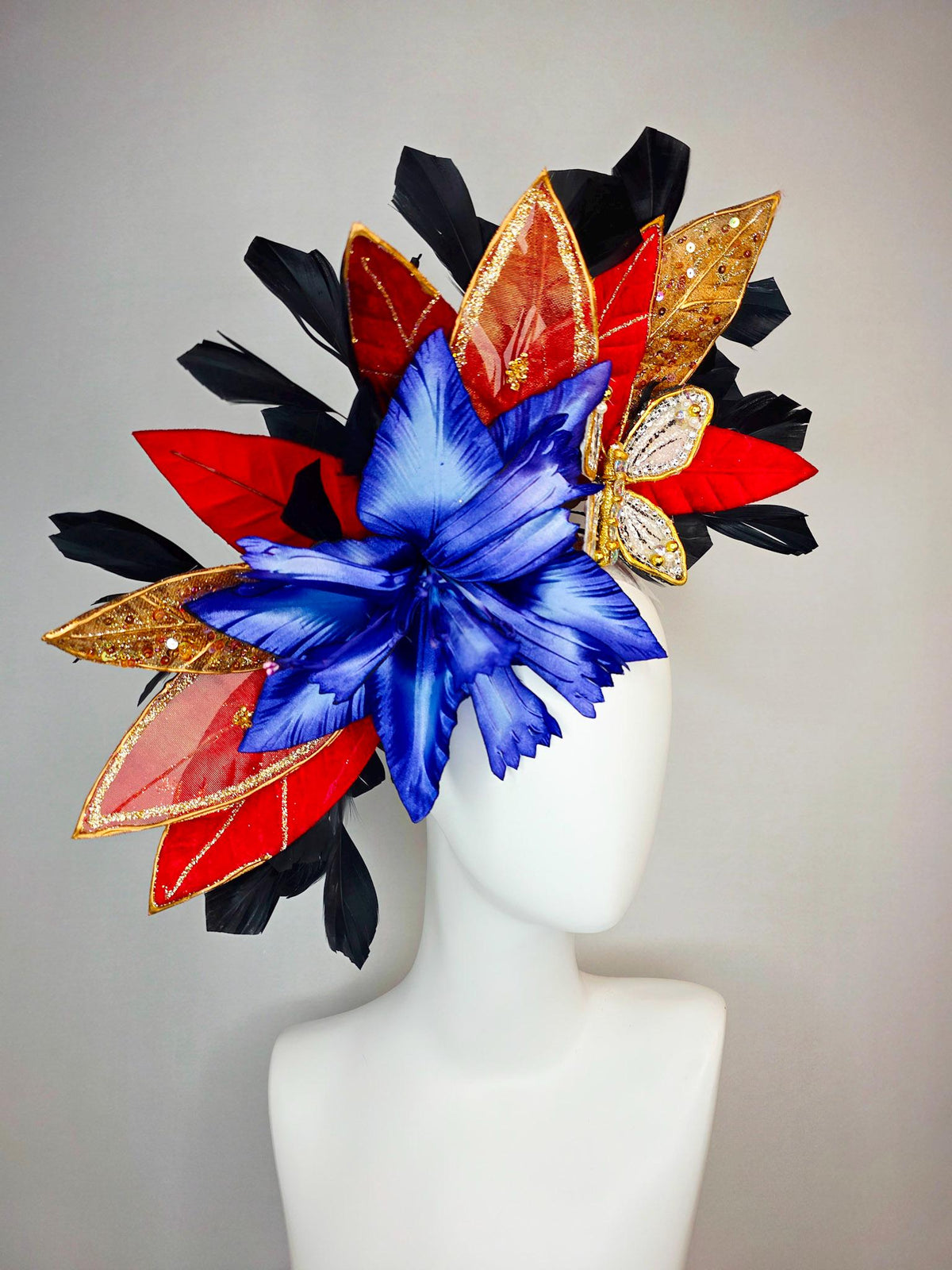 kentucky derby hat fascinator large royal blue satin flower red and gold organza satin leaves black branching feathers gold pearl butterfly