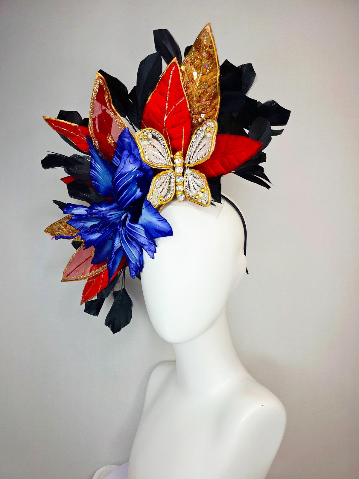 kentucky derby hat fascinator large royal blue satin flower red and gold organza satin leaves black branching feathers gold pearl butterfly