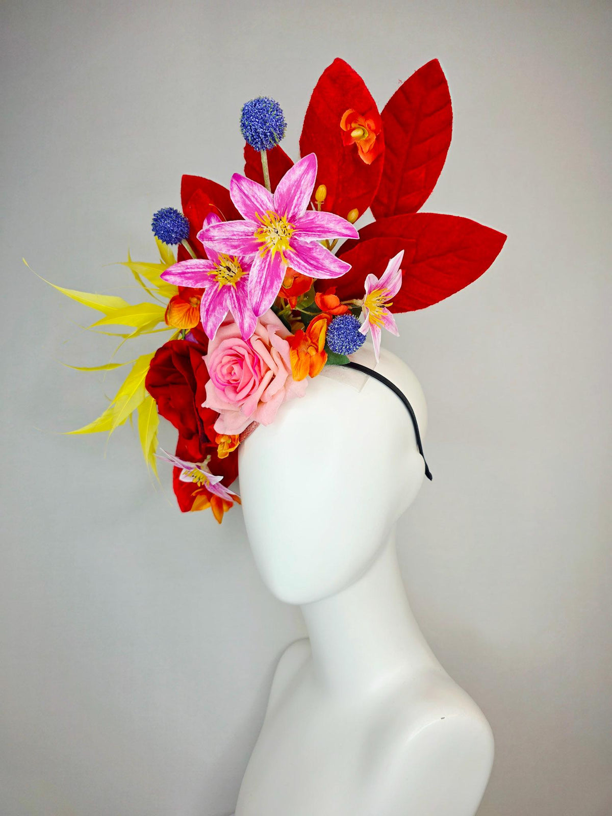 kentucky derby hat fascinator red light pink satin roses orange red pink magenta purple flowers blue thistle red leaves and yellow feathers