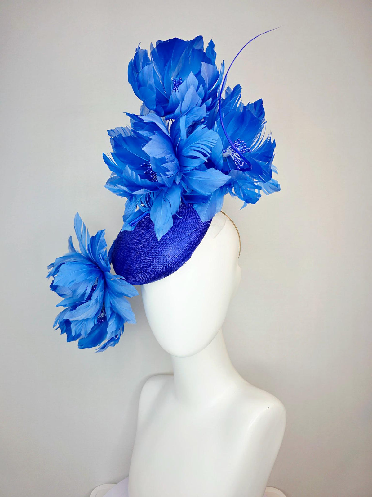 kentucky derby hat fascinator royal blue sinamay with large fluffy cobalt blue feather flowers and sky blue feathers