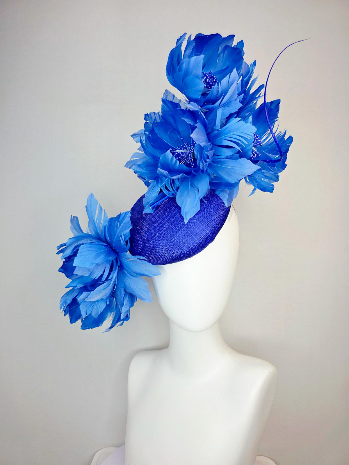 kentucky derby hat fascinator royal blue sinamay with large fluffy cobalt blue feather flowers and sky blue feathers