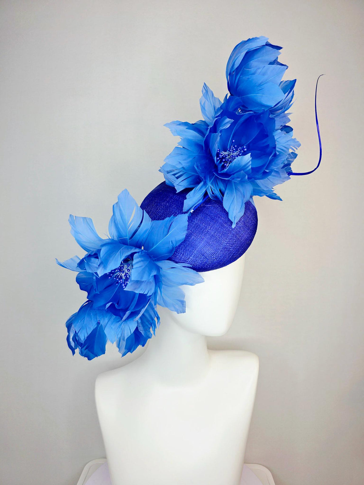 kentucky derby hat fascinator royal blue sinamay with large fluffy cobalt blue feather flowers and sky blue feathers