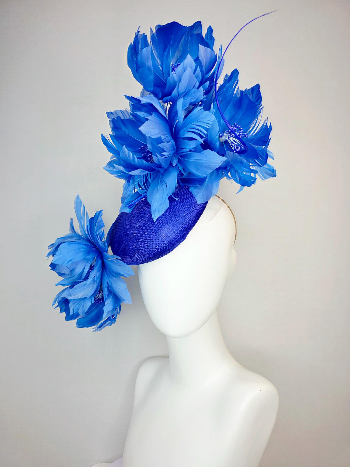 kentucky derby hat fascinator royal blue sinamay with large fluffy cobalt blue feather flowers and sky blue feathers