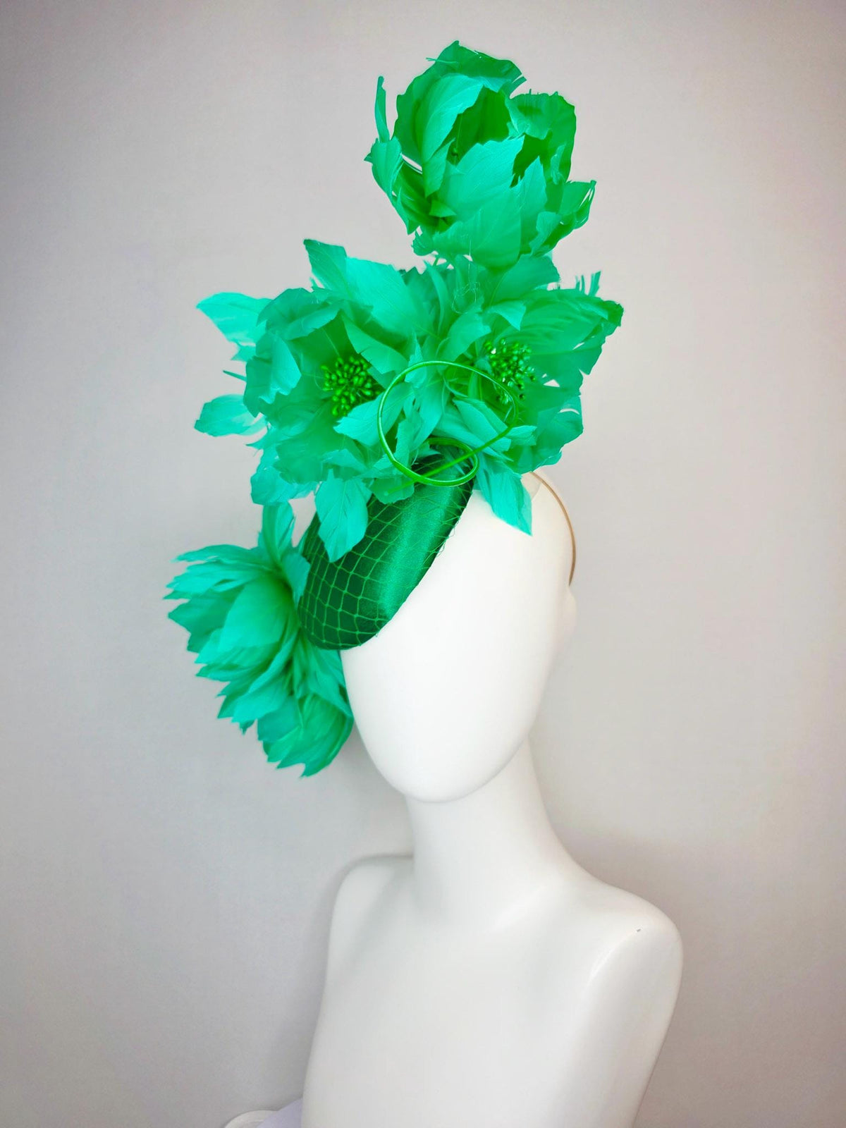 kentucky derby hat fascinator emerald green satin with netting and large fluffy green feather flowers and green feathers