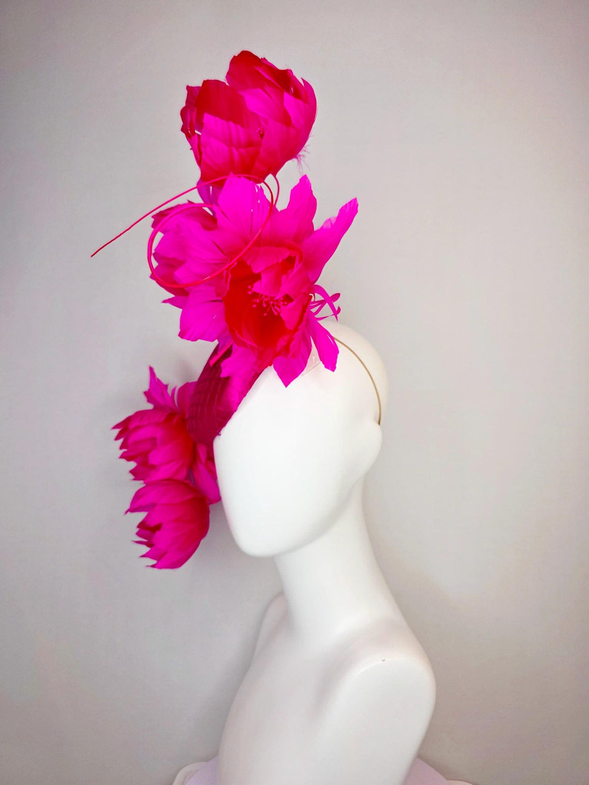 kentucky derby hat fascinator hot pink satin with netting and large fluffy hot red feather flowers with bright fuchsia pink feathers