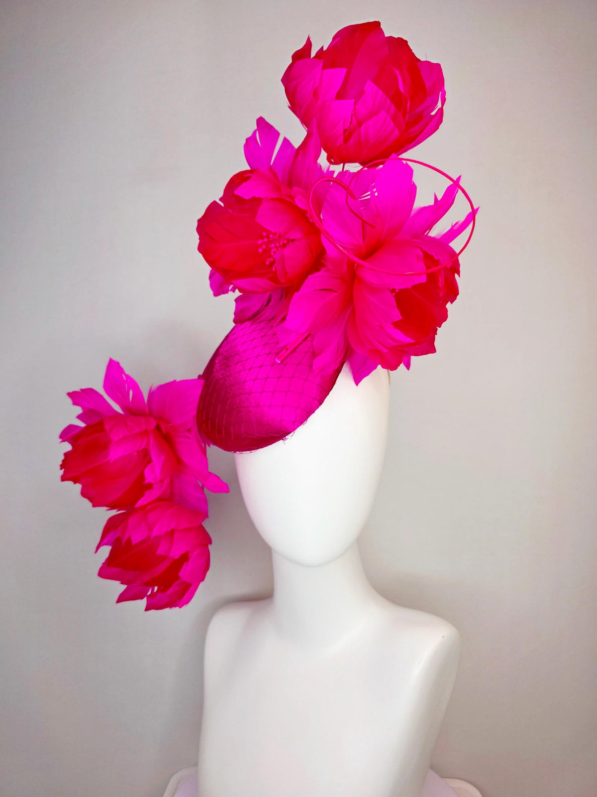 kentucky derby hat fascinator hot pink satin with netting and large fluffy hot red feather flowers with bright fuchsia pink feathers