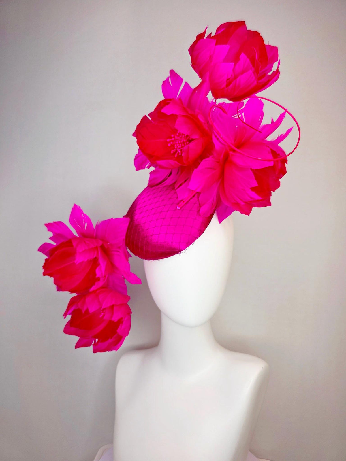kentucky derby hat fascinator hot pink satin with netting and large fluffy hot red feather flowers with bright fuchsia pink feathers