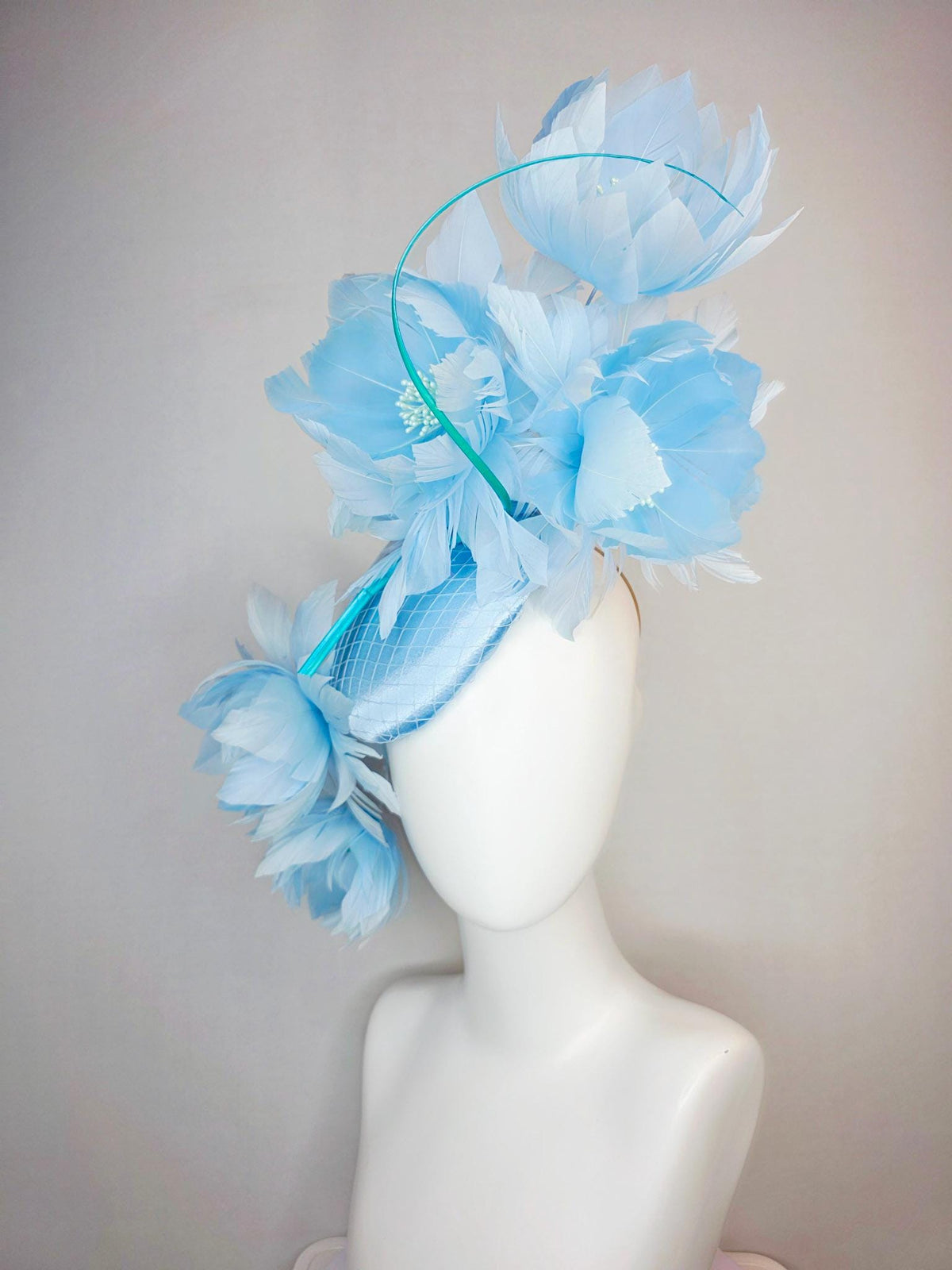 kentucky derby hat fascinator light blue satin with netting and large fluffy sky blue feather flowers and baby blue feathers