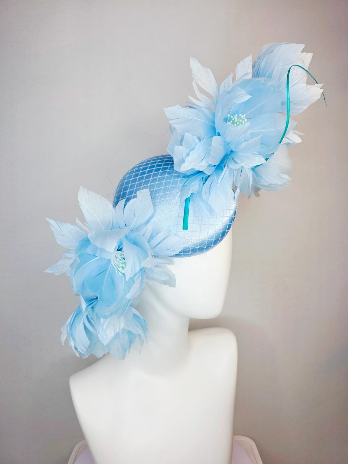 kentucky derby hat fascinator light blue satin with netting and large fluffy sky blue feather flowers and baby blue feathers