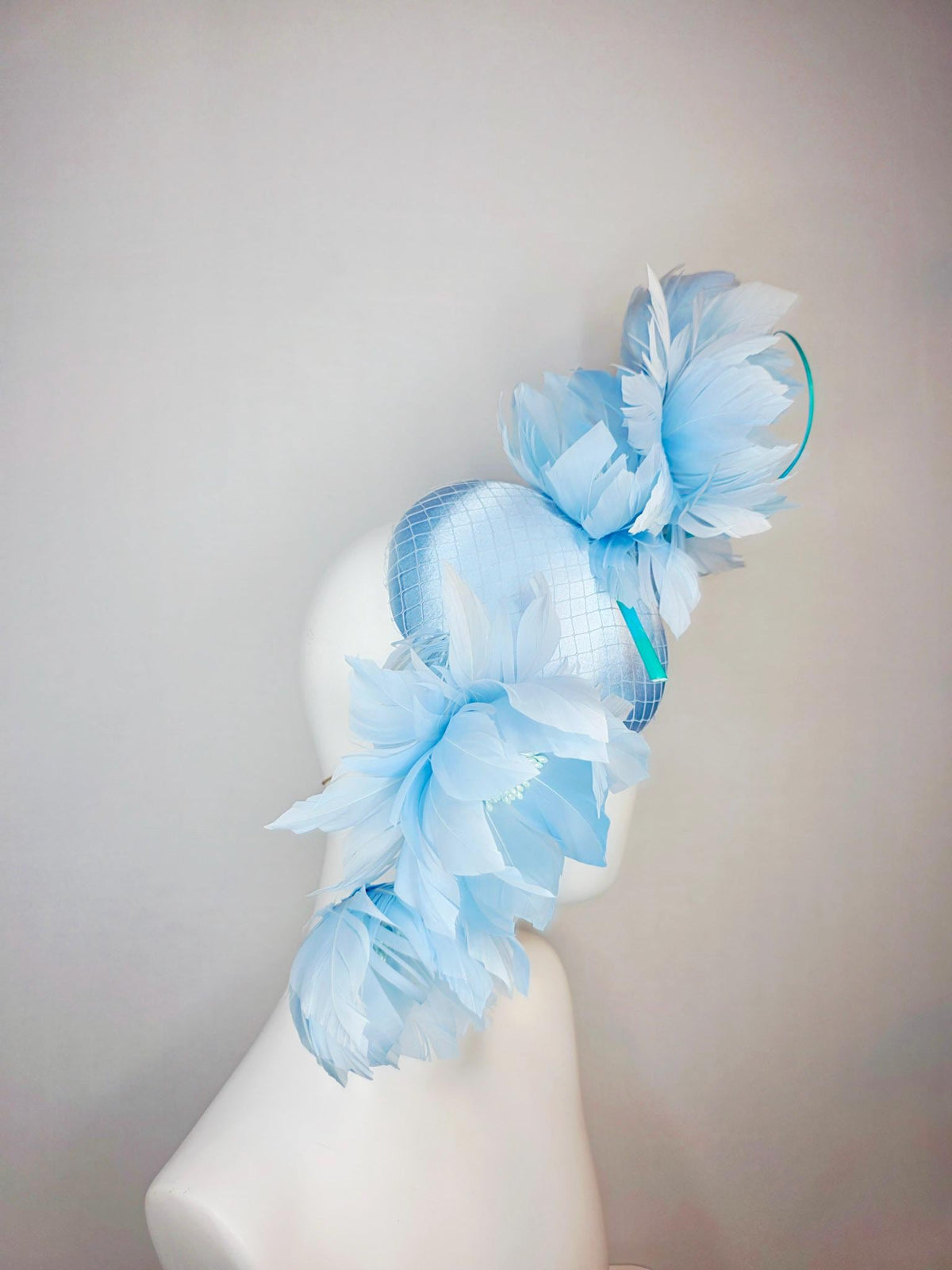 kentucky derby hat fascinator light blue satin with netting and large fluffy sky blue feather flowers and baby blue feathers