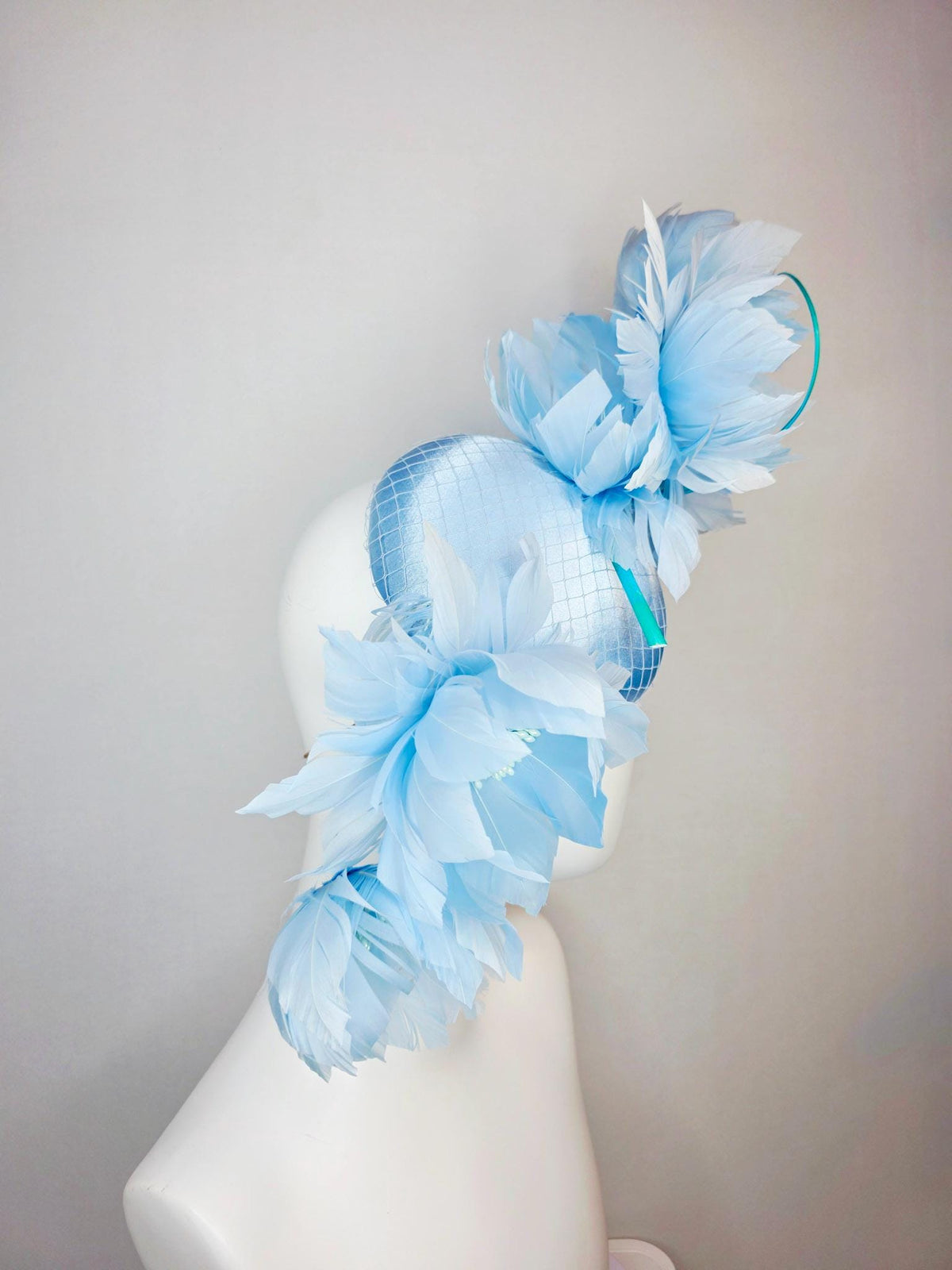 kentucky derby hat fascinator light blue satin with netting and large fluffy sky blue feather flowers and baby blue feathers