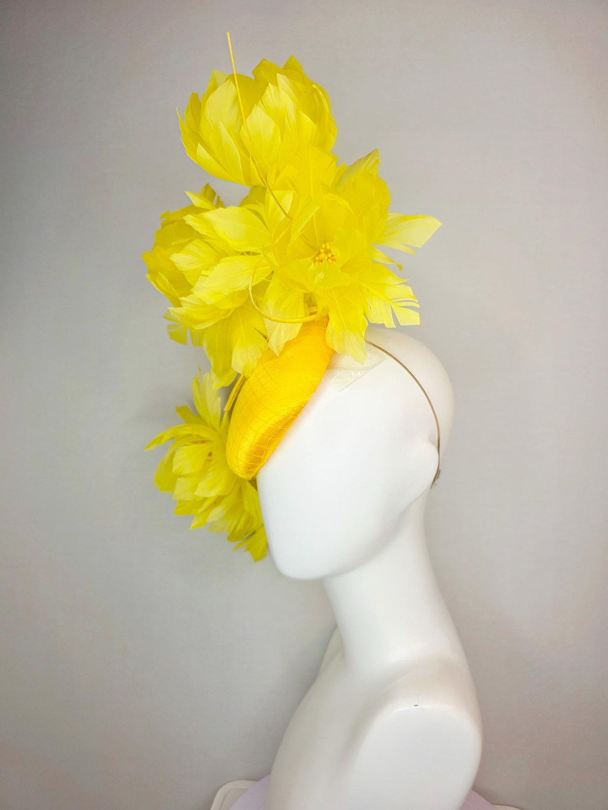 kentucky derby hat fascinator gold yellow satin with netting and large fluffy yellow feather flowers and yellow feathers