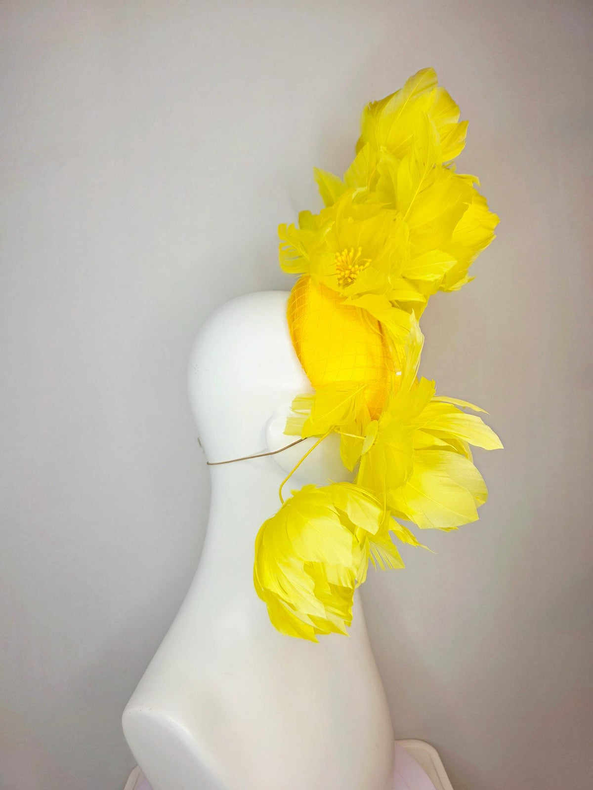 kentucky derby hat fascinator gold yellow satin with netting and large fluffy yellow feather flowers and yellow feathers
