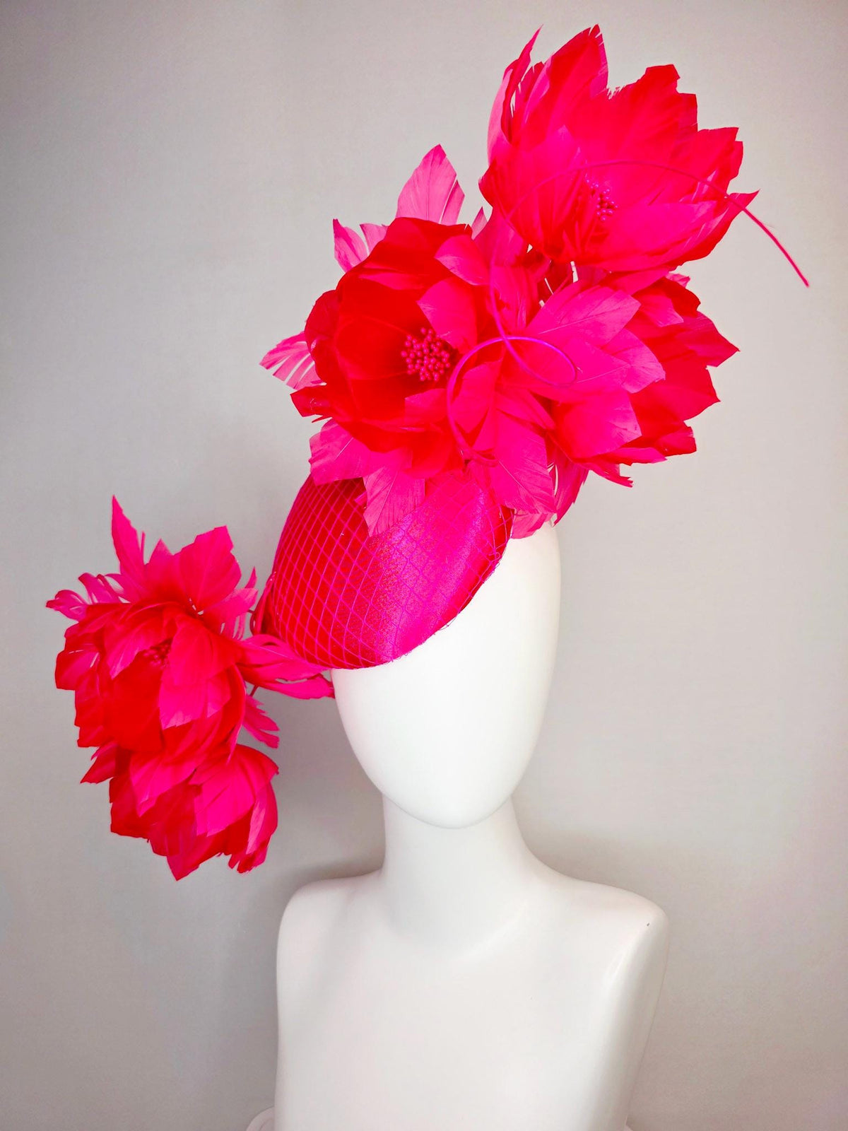 kentucky derby hat fascinator hot raspberry pink satin with netting and large fluffy red feather flowers with fuchsia pink feathers
