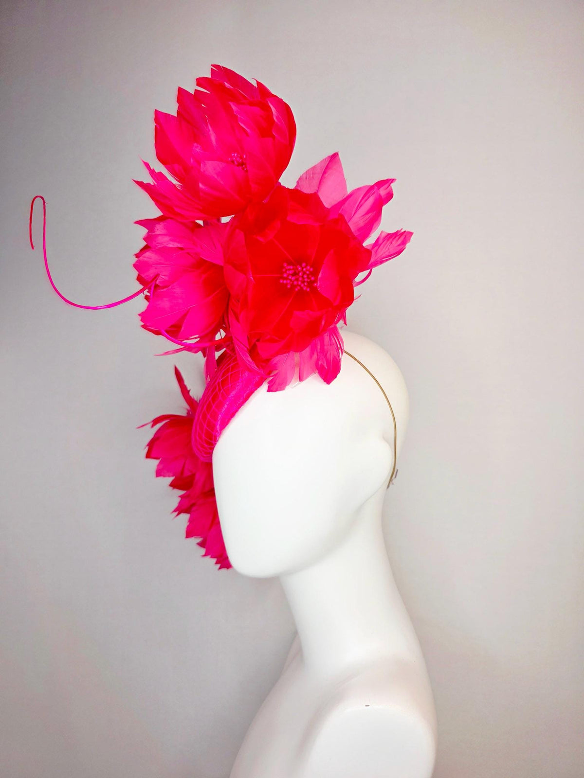 kentucky derby hat fascinator hot raspberry pink satin with netting and large fluffy red feather flowers with fuchsia pink feathers