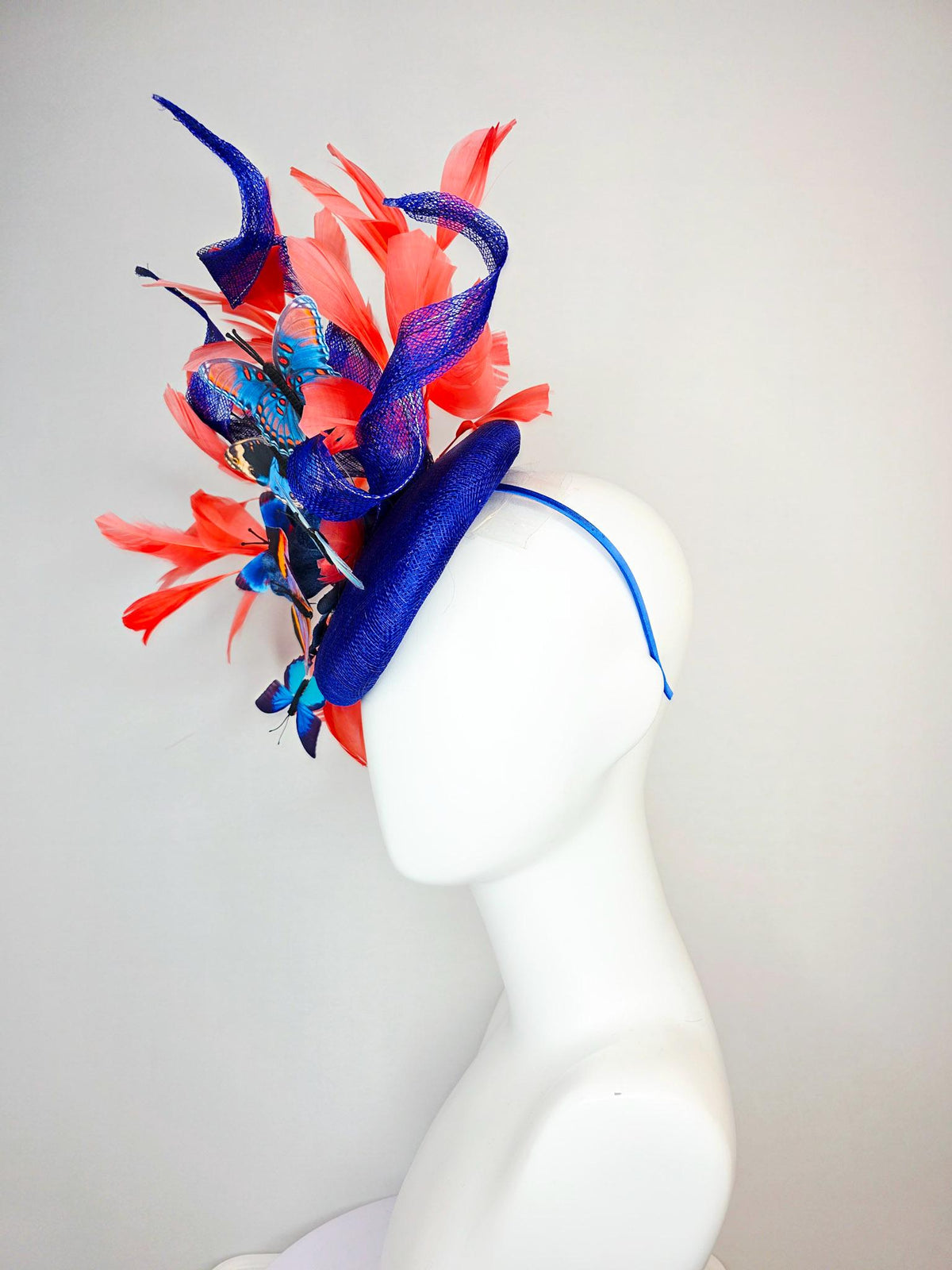 kentucky derby hat fascinator cobalt blue sinamay with curls royal blue organza flower coral orange feathers blue yellow black butterflies
