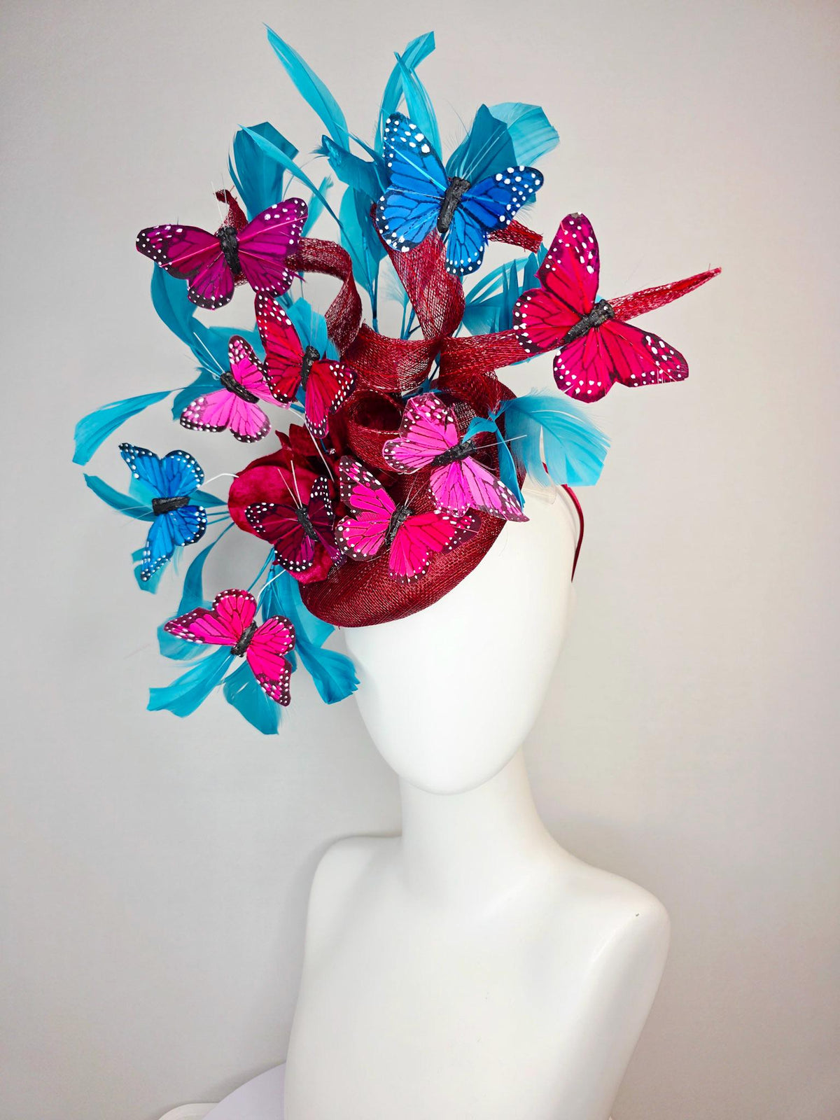 kentucky derby hat fascinator burgundy red sinamay with curls wine red organza flower turquoise sky blue feathers blue pink red butterflies