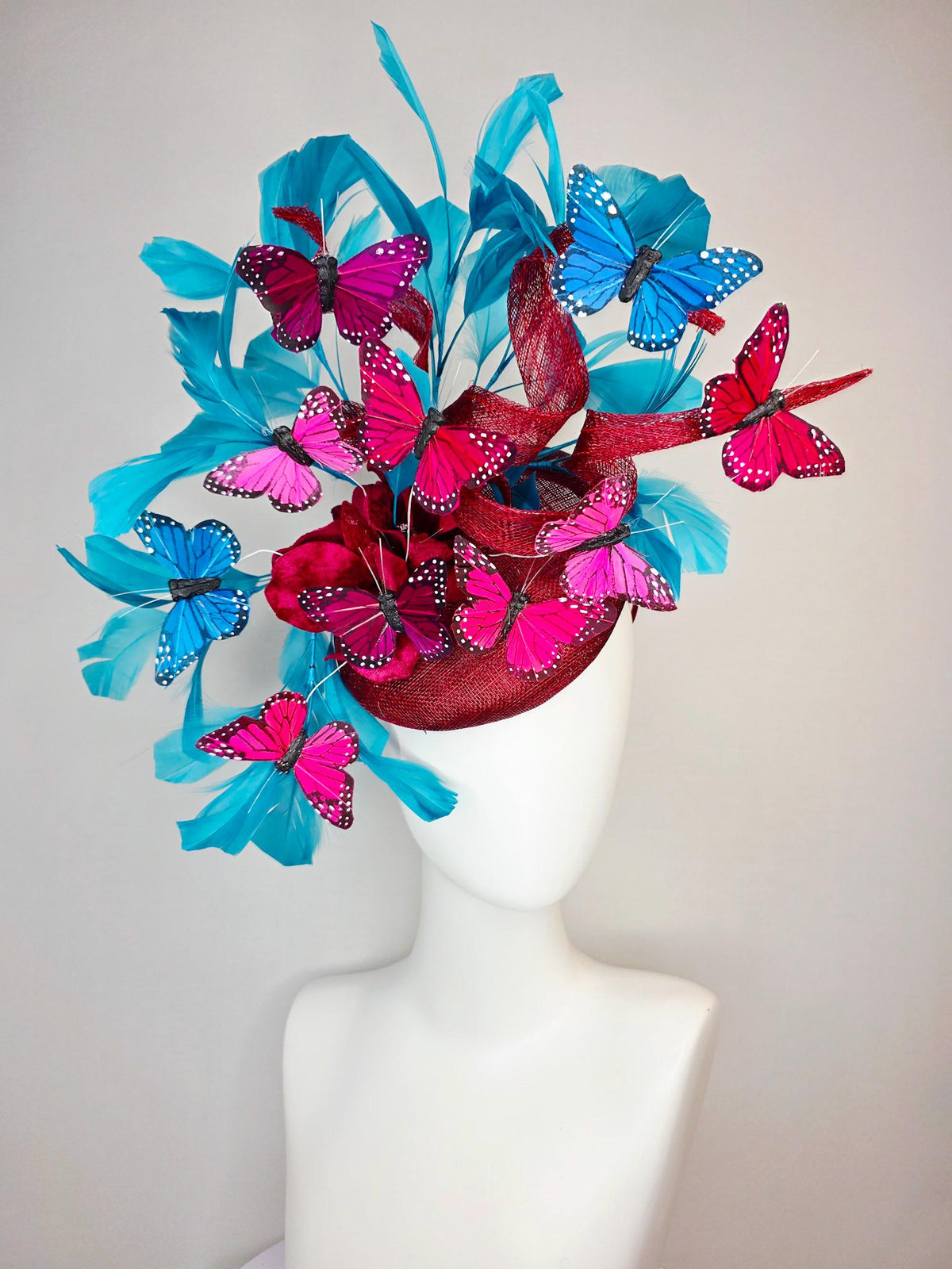 kentucky derby hat fascinator burgundy red sinamay with curls wine red organza flower turquoise sky blue feathers blue pink red butterflies