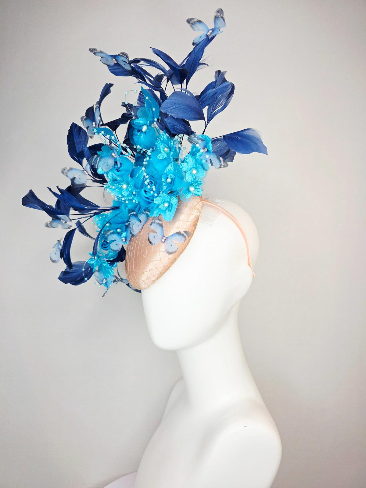 kentucky derby hat fascinator beige satin with netting ocean blue organza roses sky blue satin flowers navy blue feathers blue butterflies