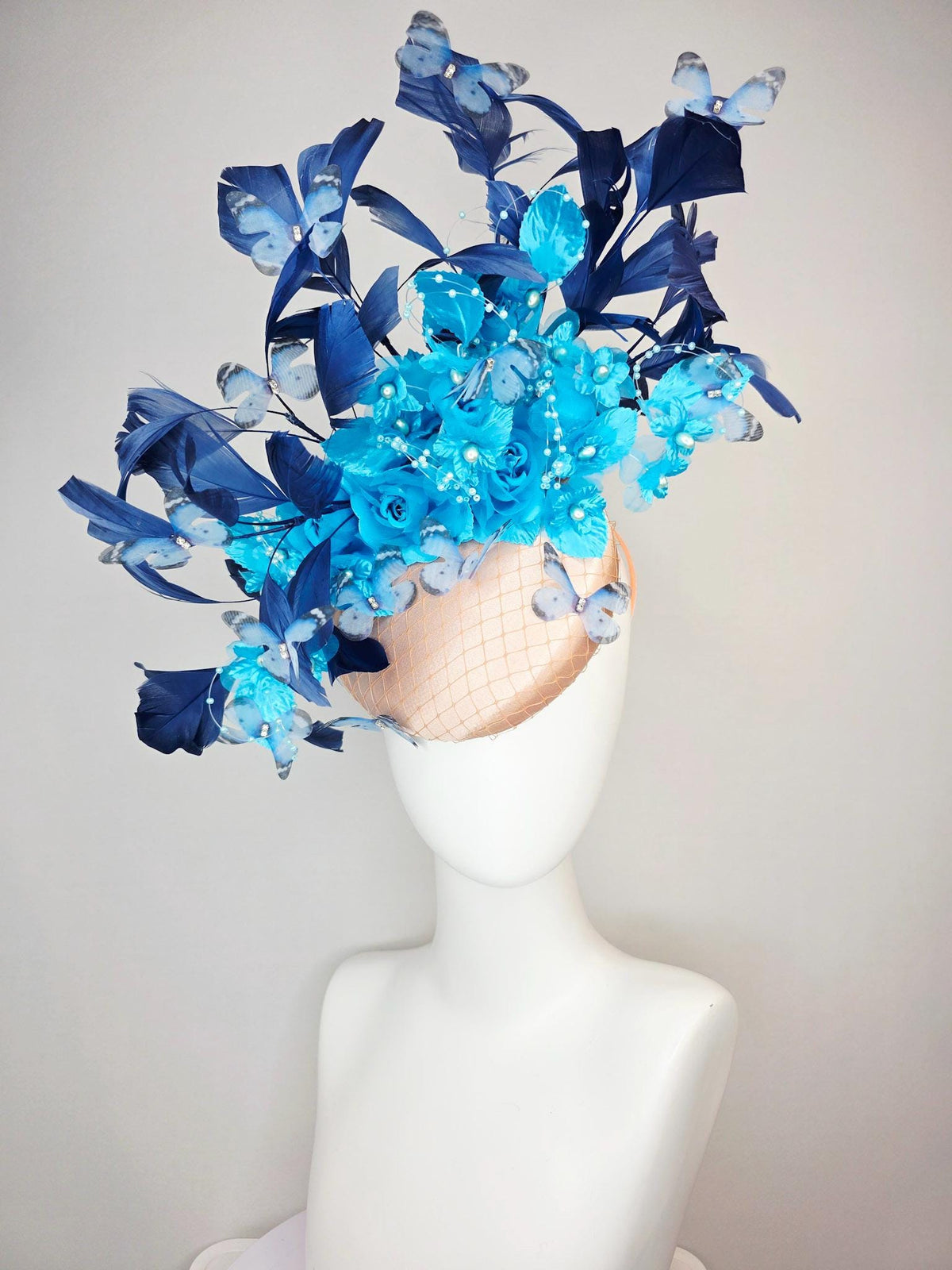 kentucky derby hat fascinator beige satin with netting ocean blue organza roses sky blue satin flowers navy blue feathers blue butterflies