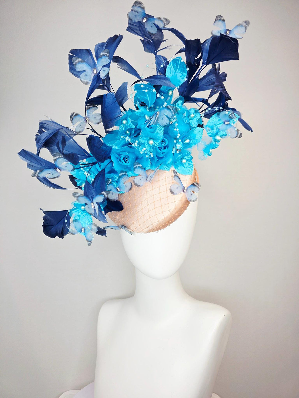 kentucky derby hat fascinator beige satin with netting ocean blue organza roses sky blue satin flowers navy blue feathers blue butterflies