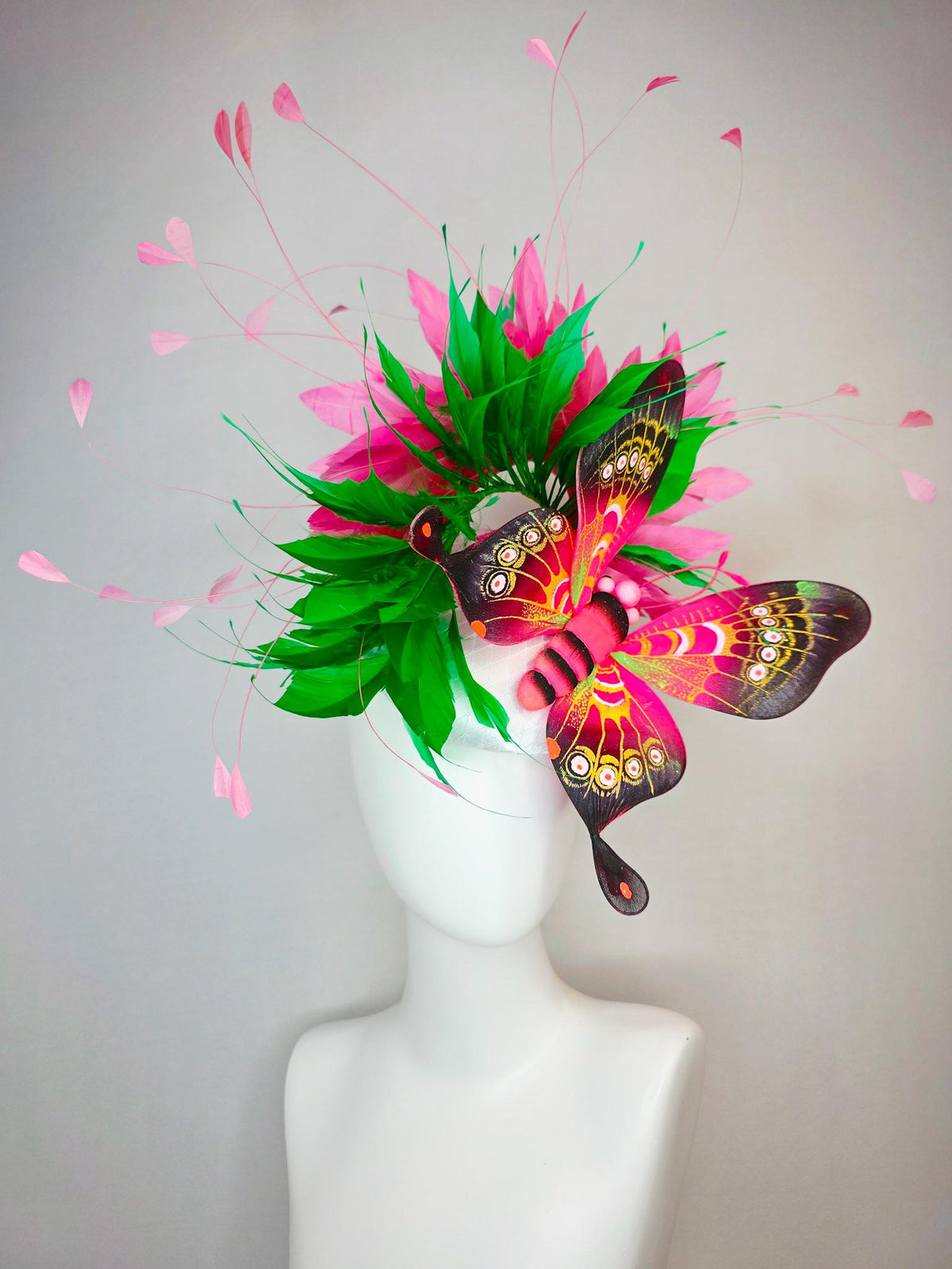 kentucky derby hat fascinator white satin with netting emerald green and hot pink branching feathers with large pink yellow black butterfly