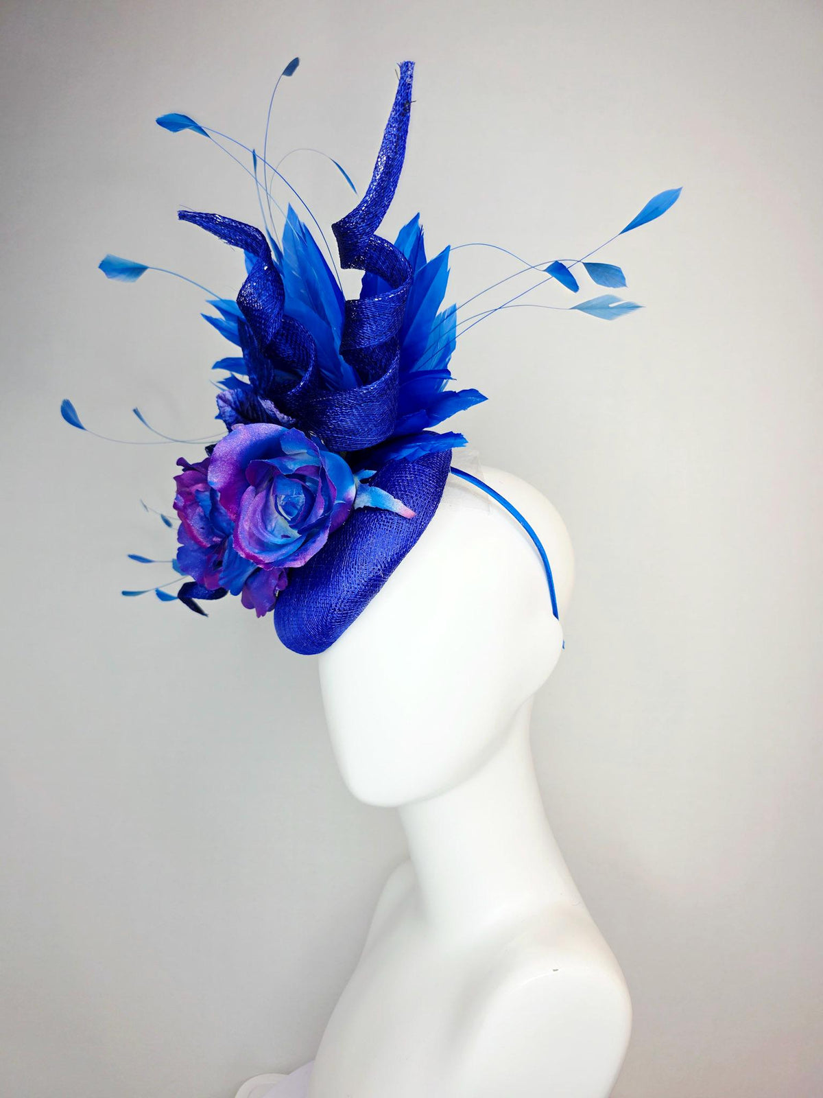 kentucky derby hat fascinator cobalt blue sinamay with curls ombre pink purple blue satin roses blue leaves royal blue branching feathers