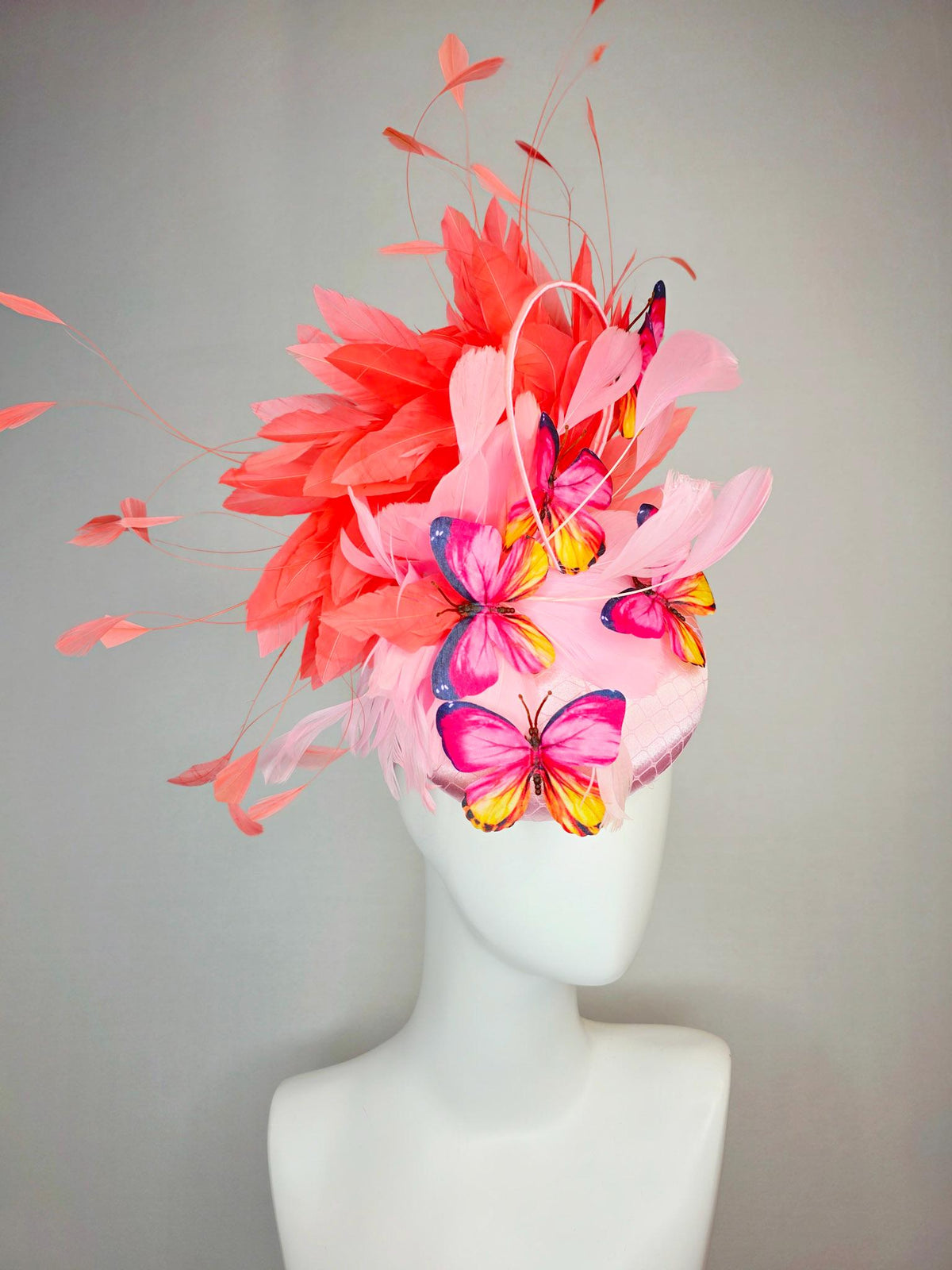 kentucky derby hat fascinator light pink satin with netting baby pink coral orange branching feathers and pink yellow navy blue butterflies