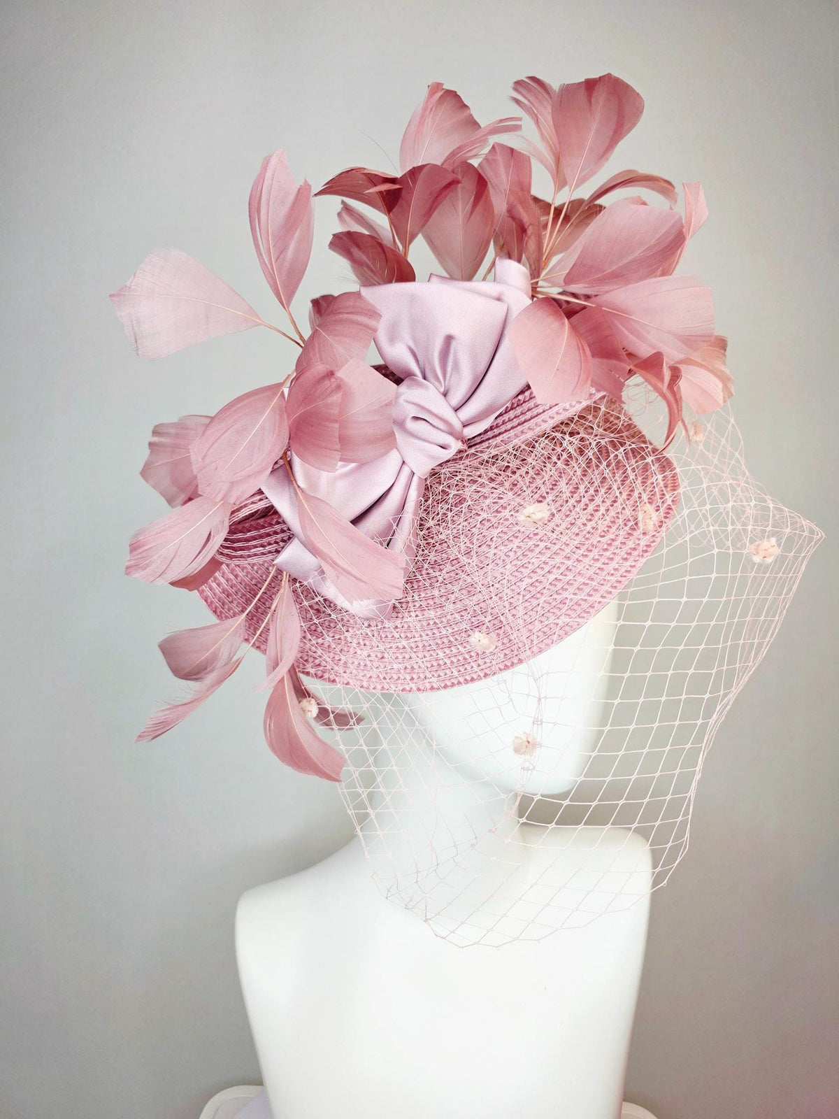 kentucky derby hat fascinator dusty mauve pink straw saucer with lilac pink satin bow dusty pink branching feathers light pink mesh veil