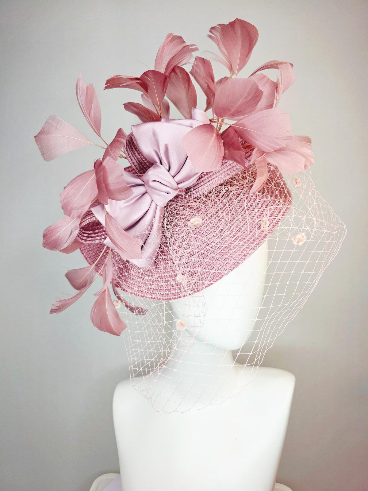 kentucky derby hat fascinator dusty mauve pink straw saucer with lilac pink satin bow dusty pink branching feathers light pink mesh veil