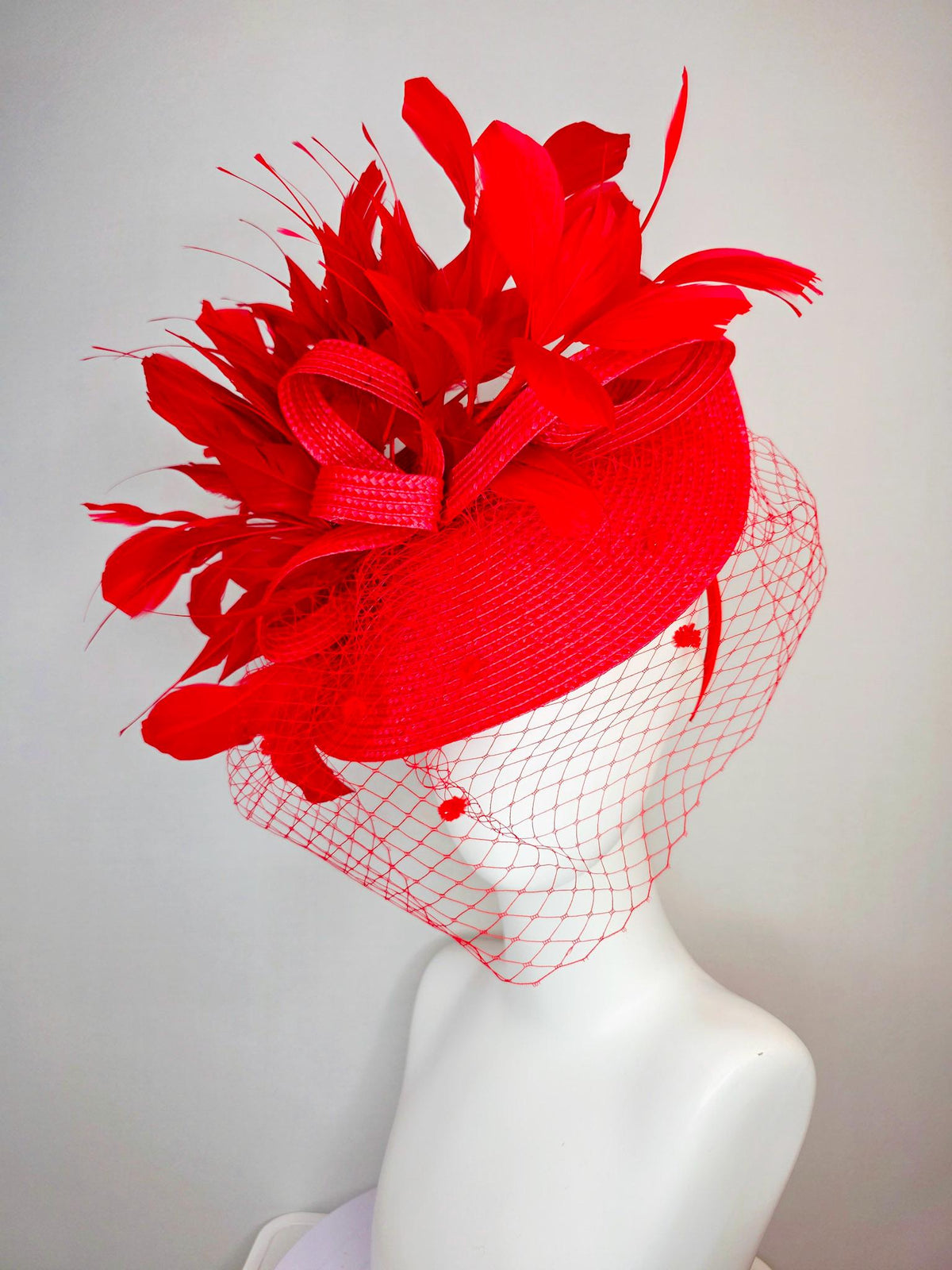 kentucky derby hat fascinator scarlet red straw saucer with red straw bow with bright red branching feathers and red mesh veil