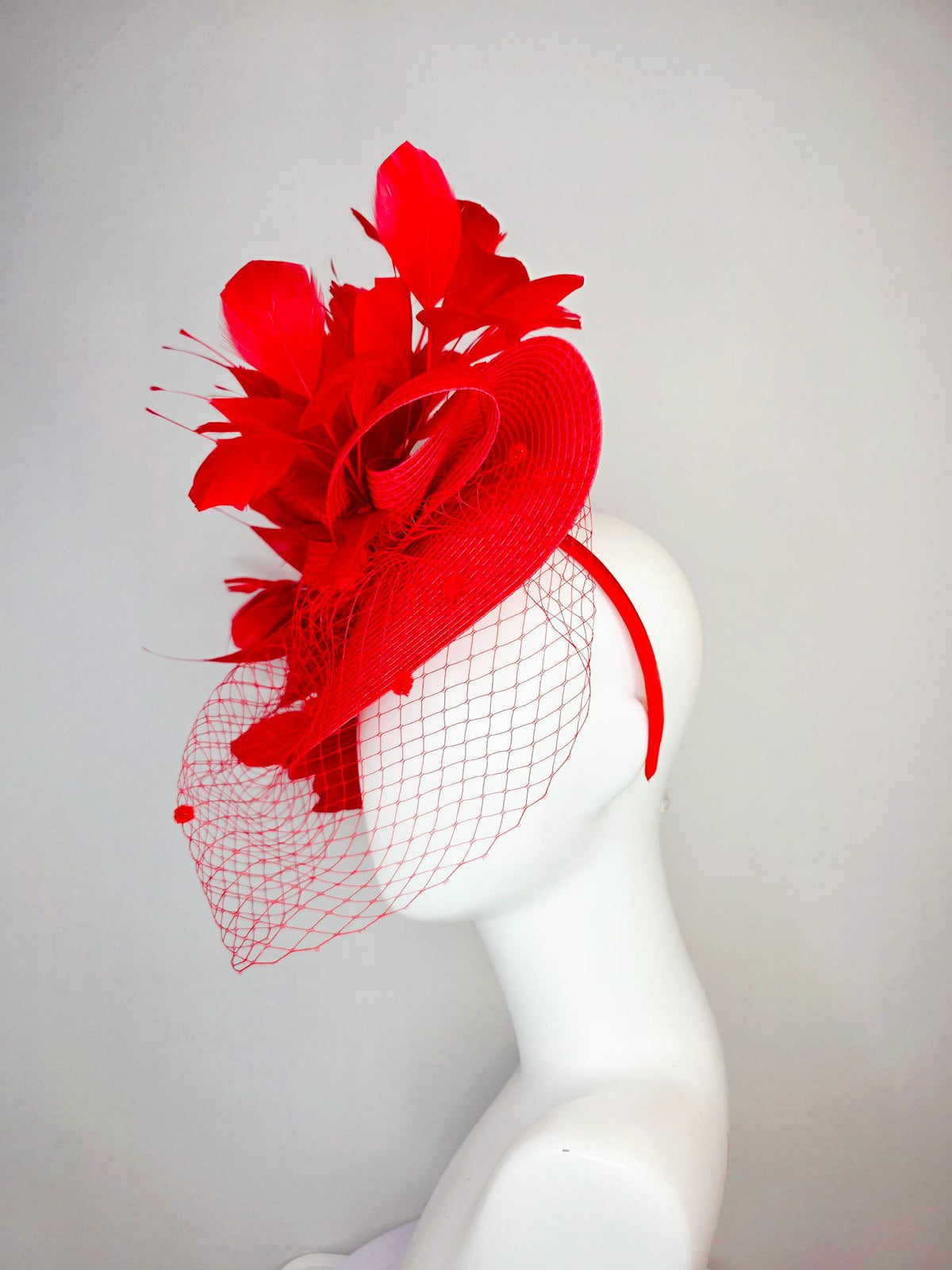 kentucky derby hat fascinator scarlet red straw saucer with red straw bow with bright red branching feathers and red mesh veil