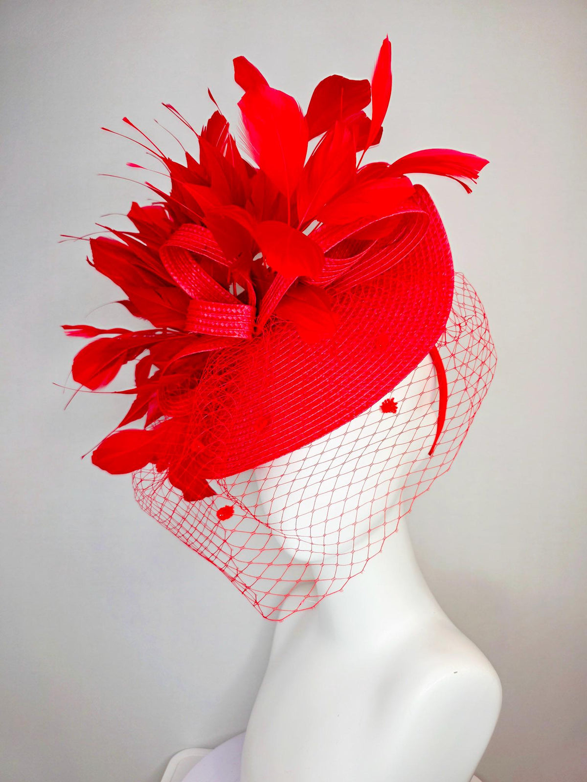 kentucky derby hat fascinator scarlet red straw saucer with red straw bow with bright red branching feathers and red mesh veil