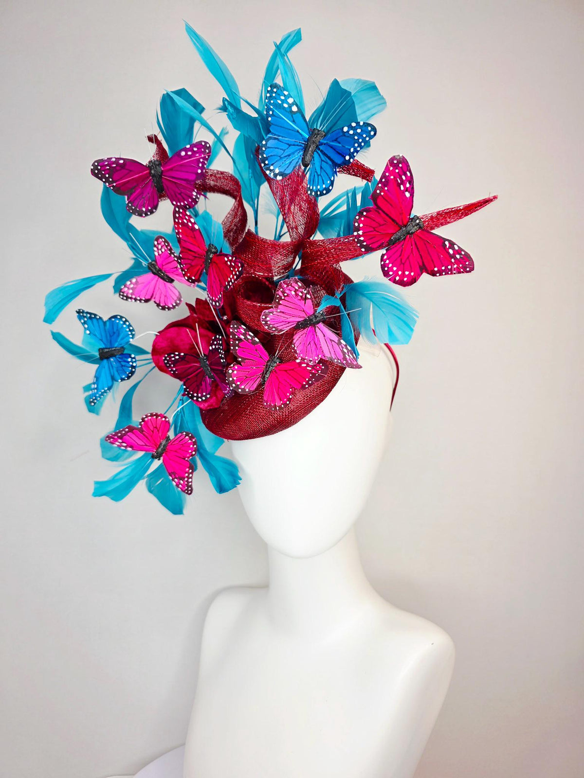 kentucky derby hat fascinator burgundy red sinamay with curls wine red organza flower turquoise sky blue feathers blue pink red butterflies