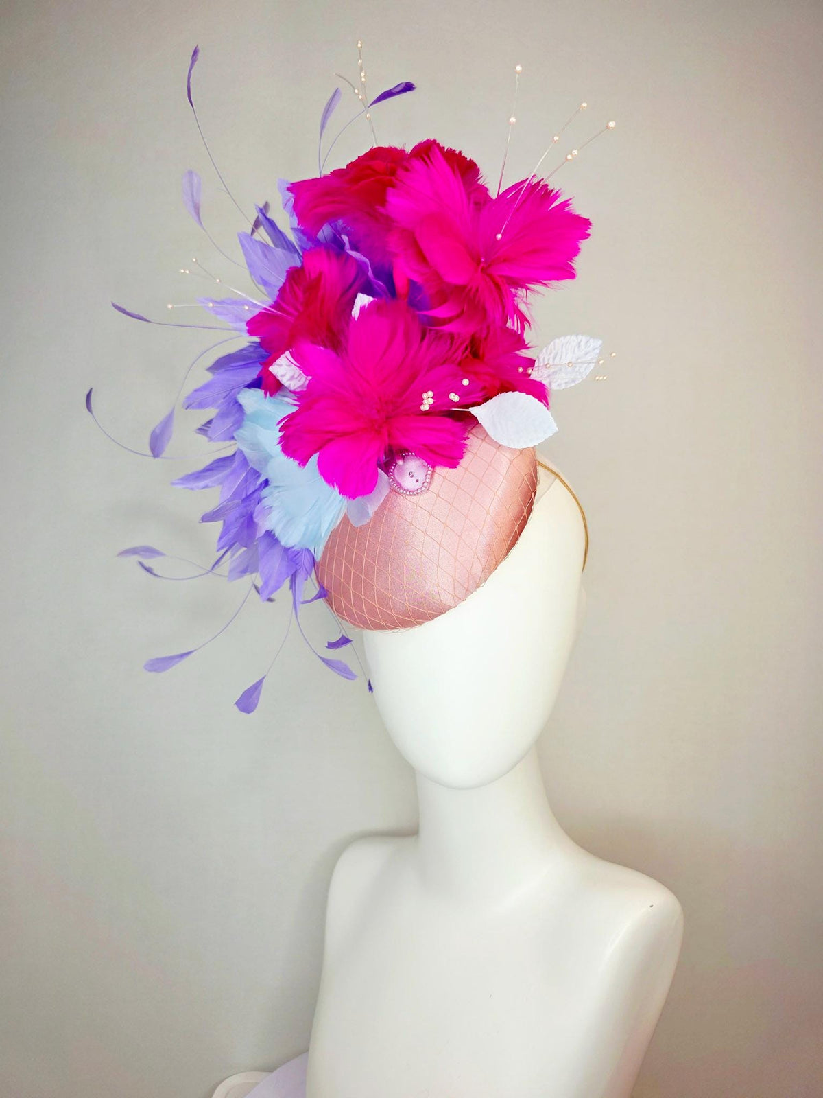 kentucky derby hat fascinator dusty pink satin with netting light blue fuchsia pink feather flowers white leaves lavender purple feathers
