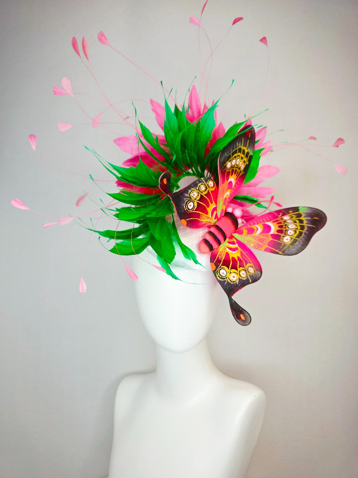 kentucky derby hat fascinator white satin with netting emerald green and hot pink branching feathers with large pink yellow black butterfly
