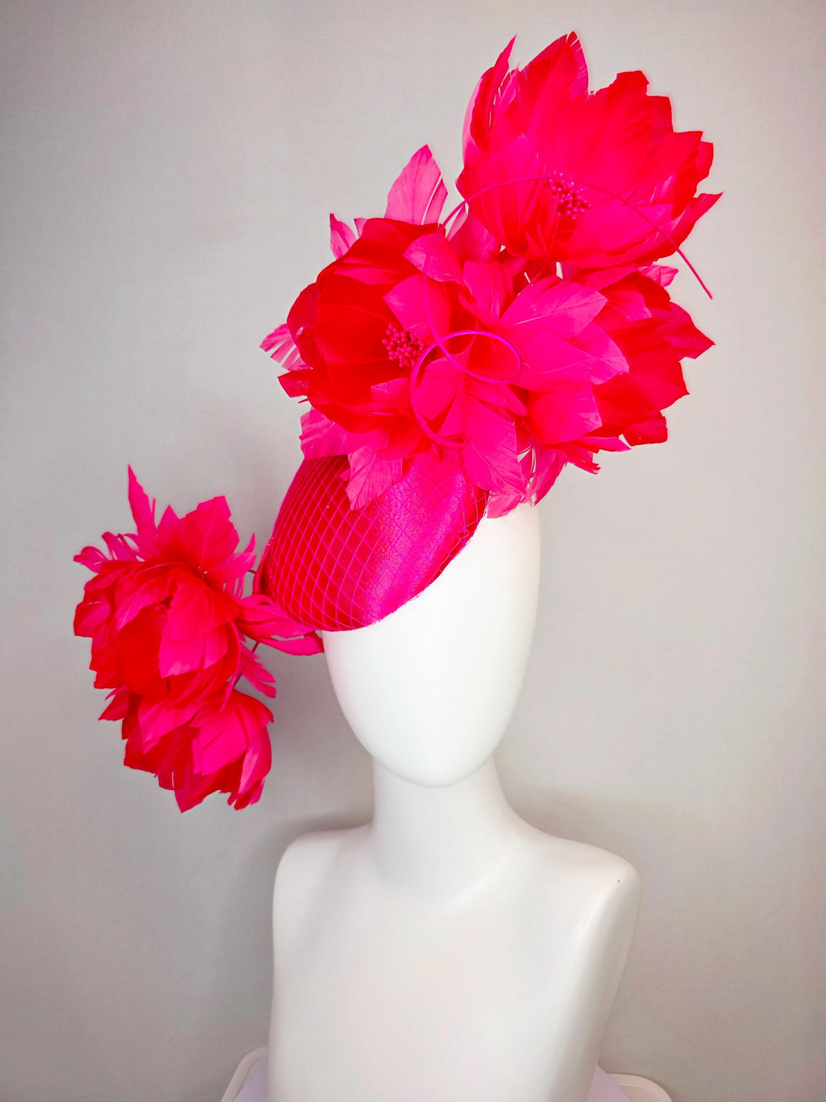 kentucky derby hat fascinator hot raspberry pink satin with netting and large fluffy red feather flowers with fuchsia pink feathers