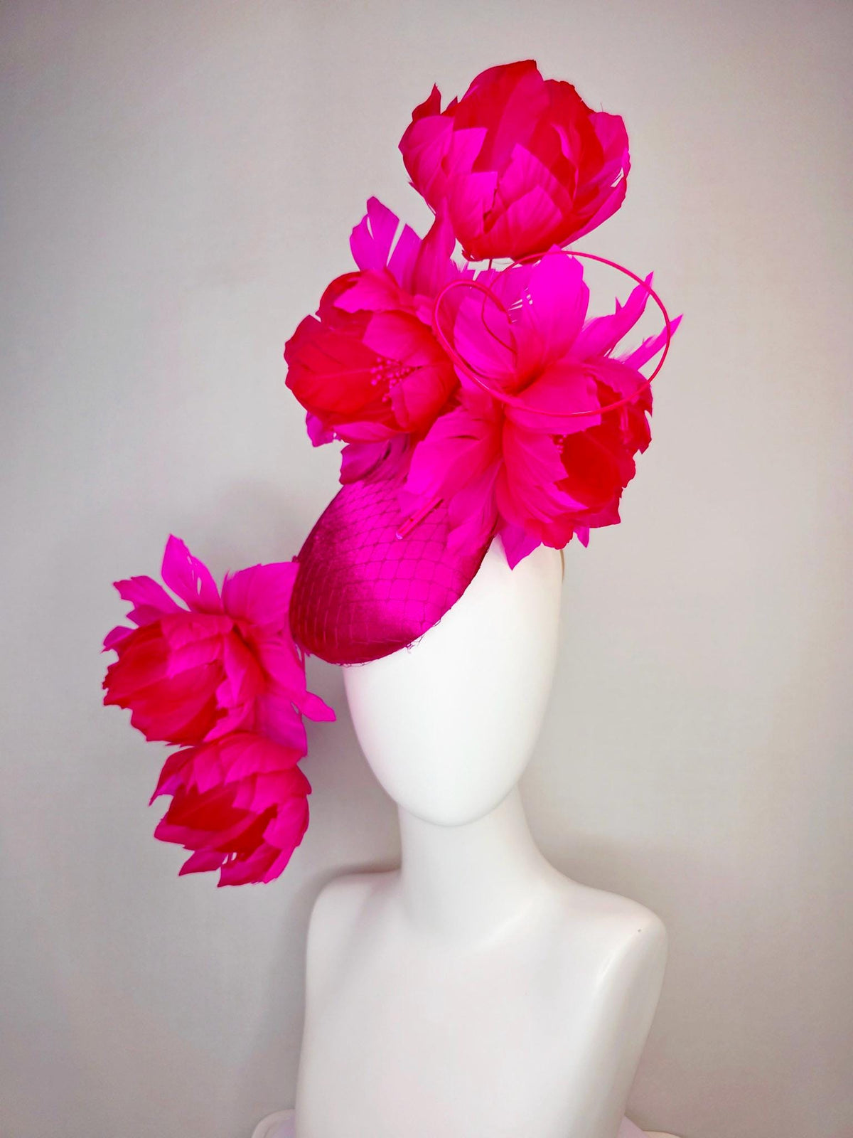 kentucky derby hat fascinator hot pink satin with netting and large fluffy hot red feather flowers with bright fuchsia pink feathers